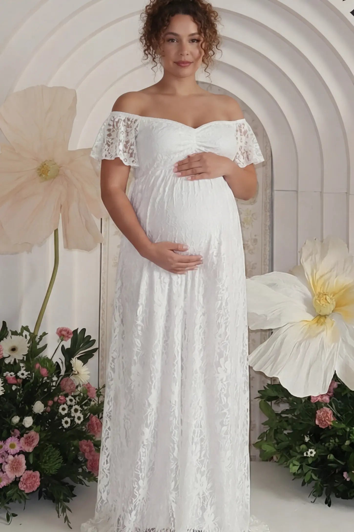 Floral Lace Off Shoulder Maternity Maxi Dress Floral Lace Off The Shoulder Maternity Maxi Dress featuring a ruched bust in White on a pregnant model.