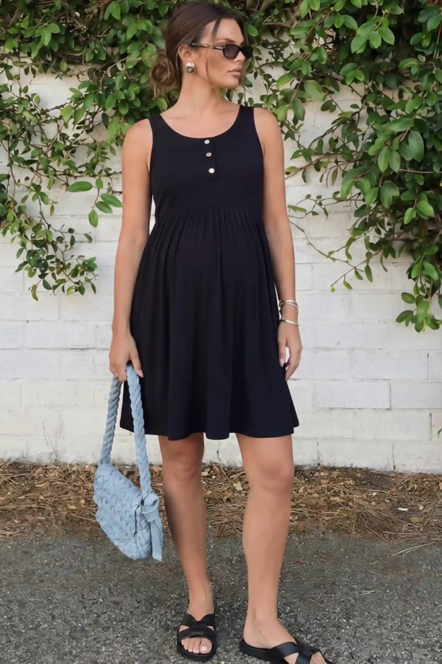 Button Accent Sleeveless Maternity Short Dress in Black featuring an empire waist on a pregnant model.