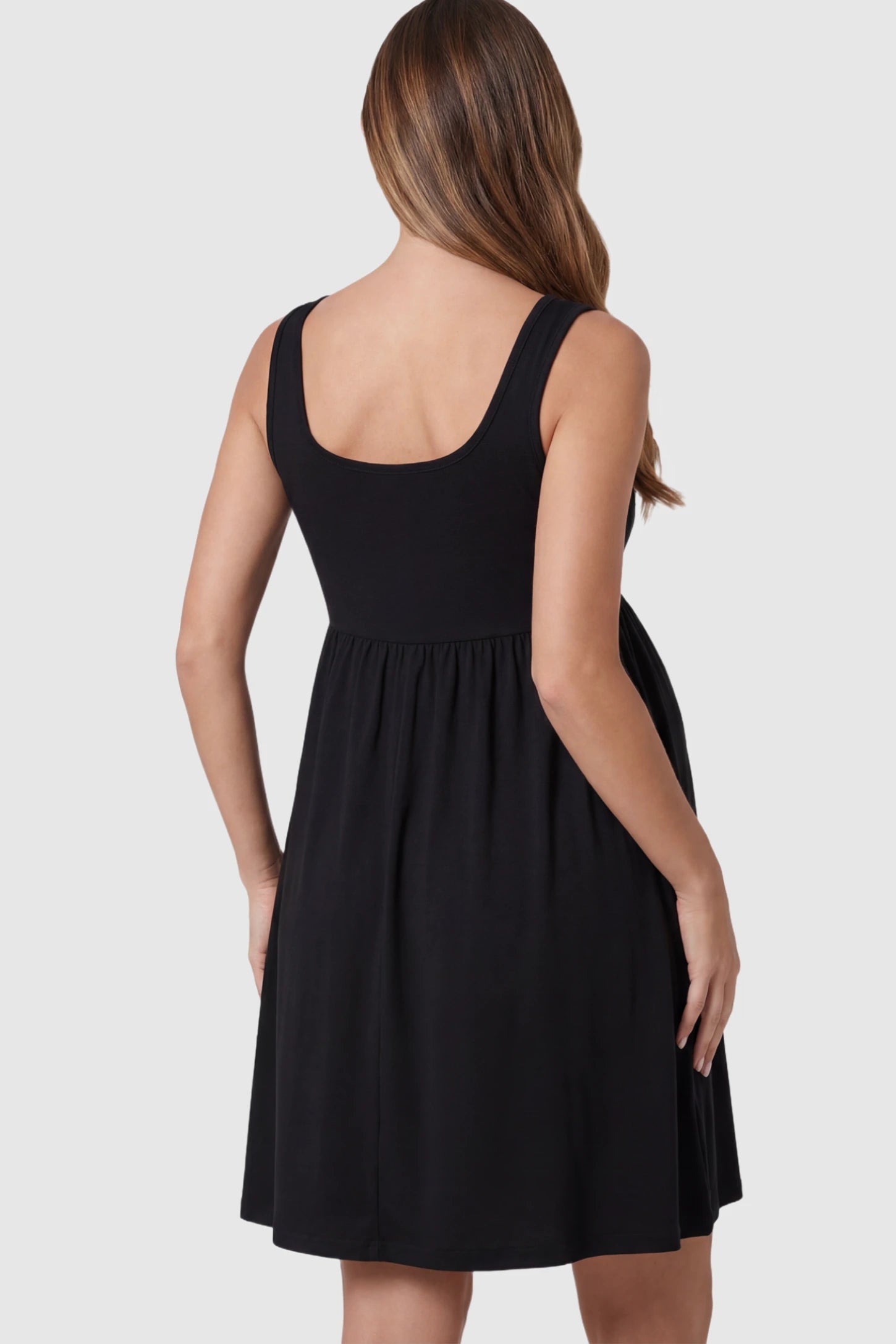 Button Accent Sleeveless Maternity Short Dress Button Accent Sleeveless Maternity Short Dress in Black on a pregnant model.