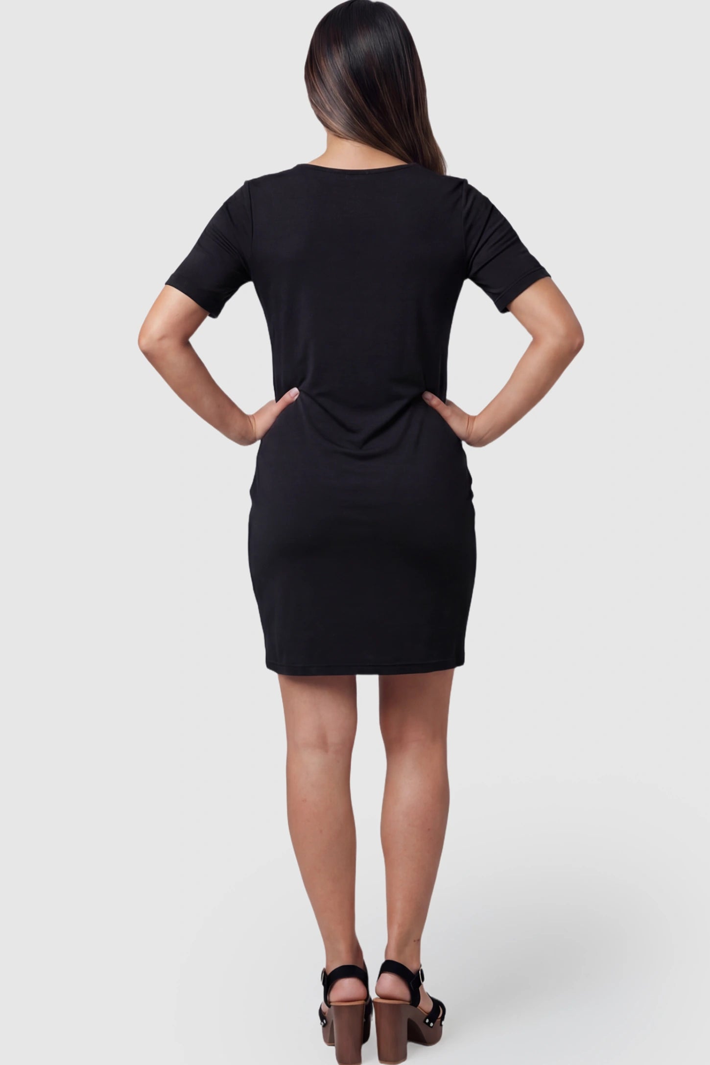 Draped Ruched Wrap Front Maternity Nursing Dress Draped Ruched Wrap Front Maternity Nursing Dress in Black with short sleeves on a pregnant model.