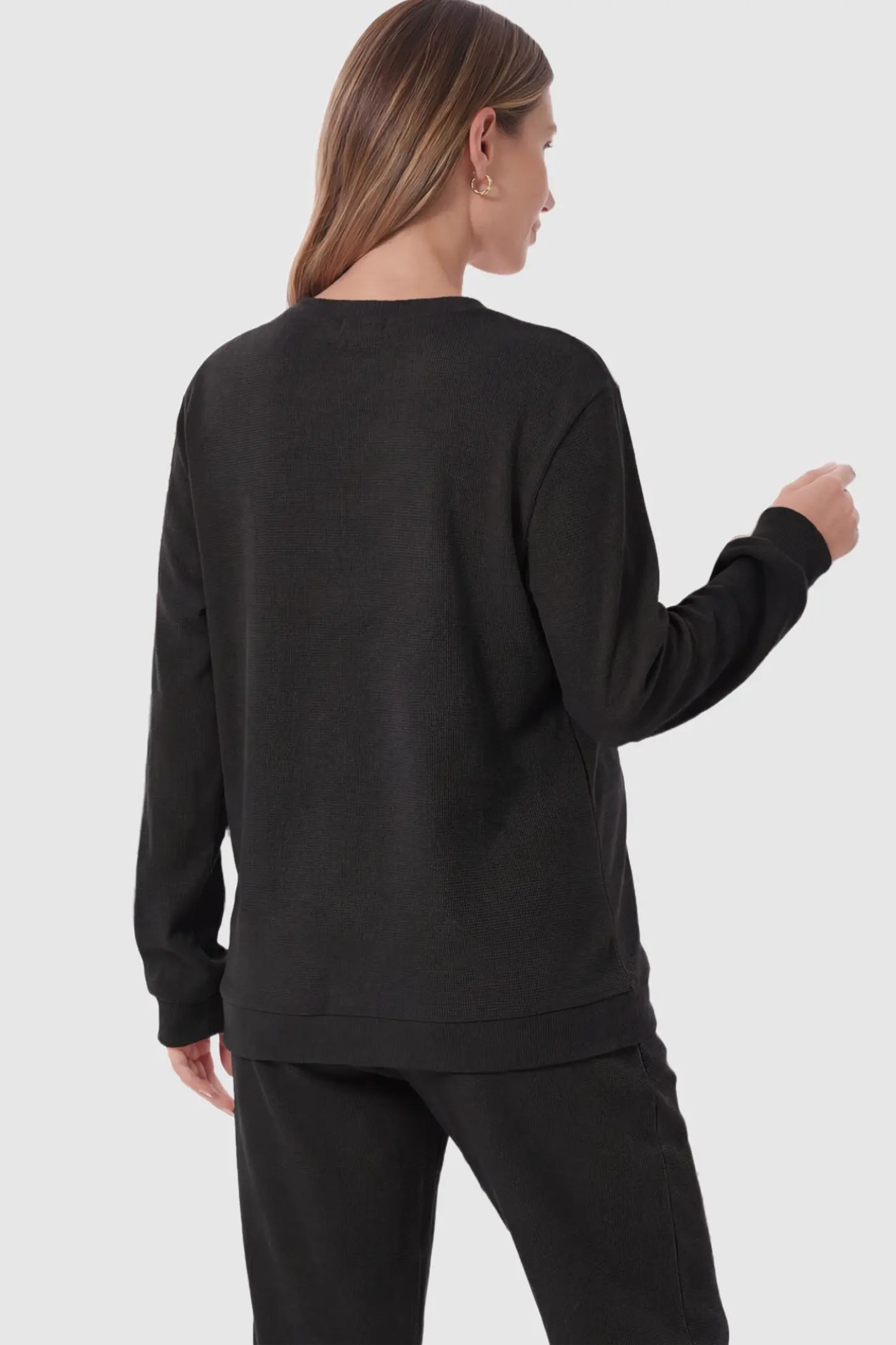 Waffle Knit Long Sleeve Maternity Pullover Sweatshirt Waffle Knit Long Sleeve Maternity Pullover Sweatshirt in Black on a pregnant model.