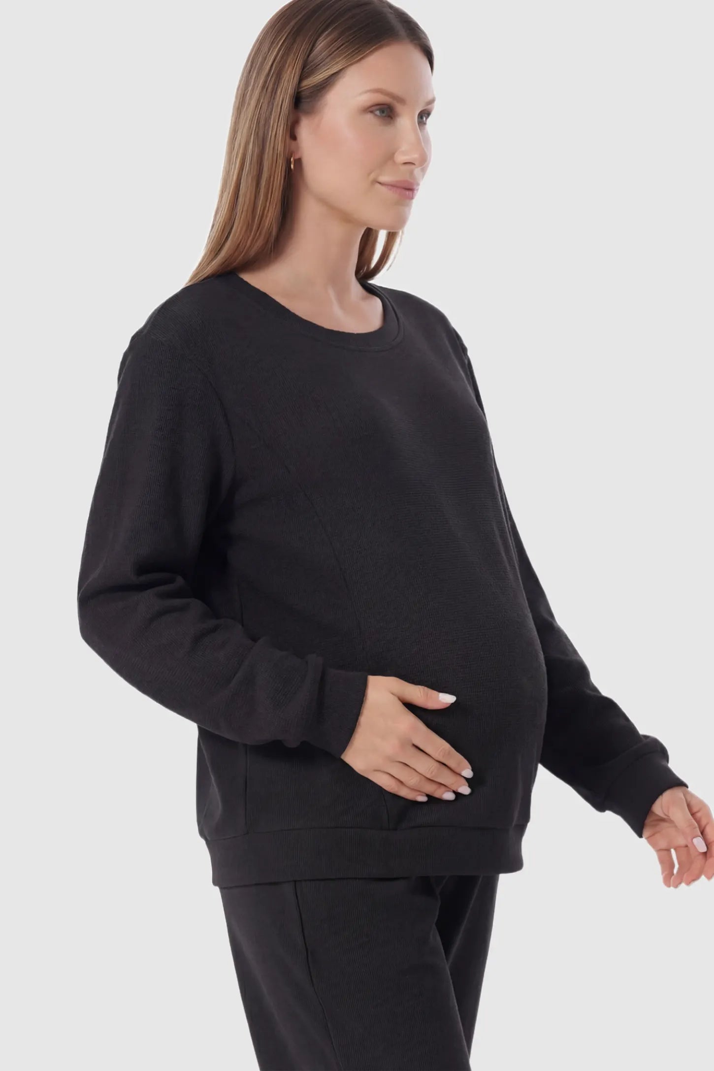 Waffle Knit Long Sleeve Maternity Pullover Sweatshirt in Black featuring hidden nursing zippers on a pregnant model.