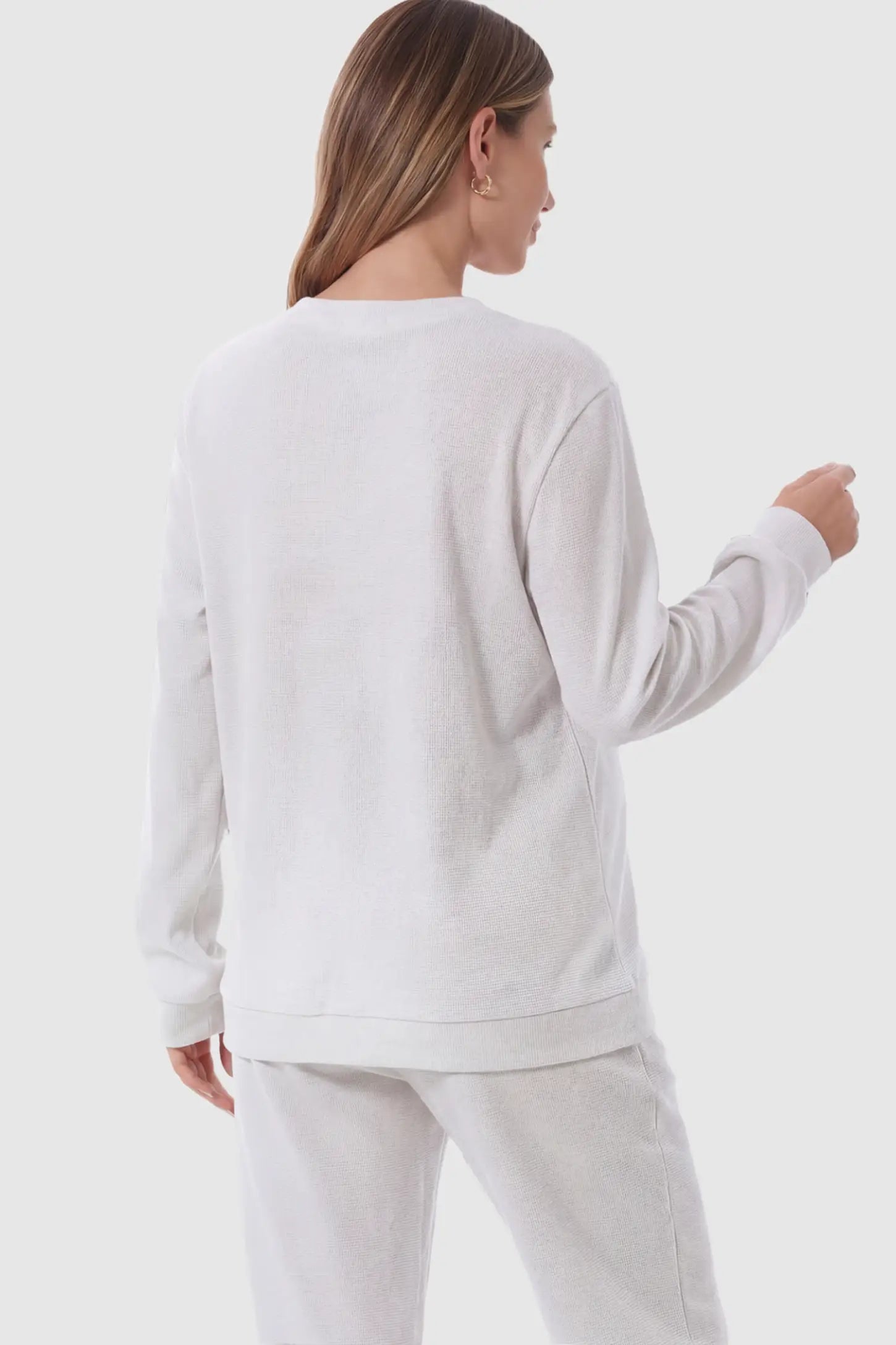 Waffle Knit Long Sleeve Maternity Pullover Sweatshirt Waffle Knit Long Sleeve Maternity Pullover Sweatshirt in White on a pregnant model.