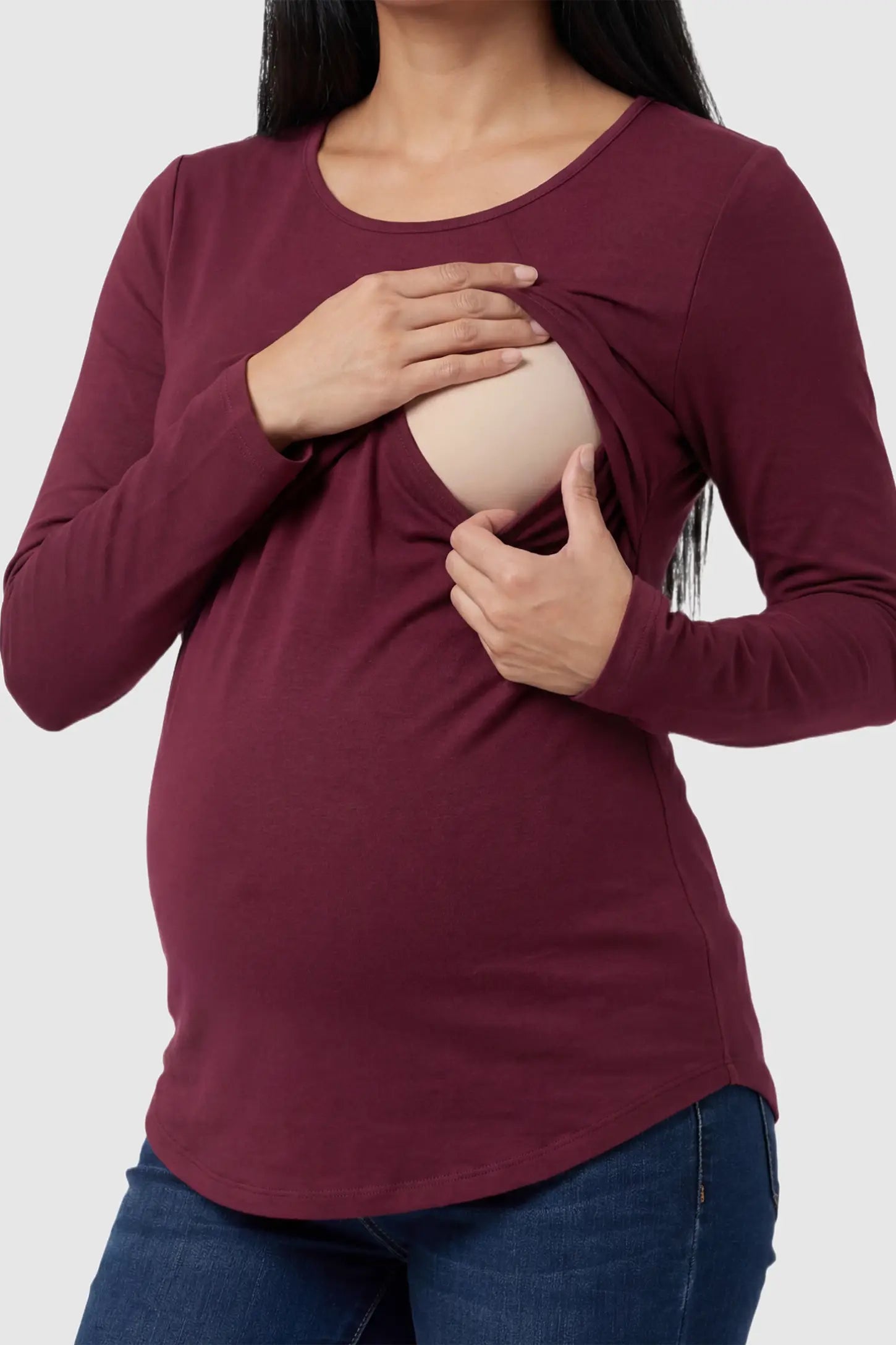 Solid Crew Neck Long Sleeve Maternity & Nursing Top Solid Crew Neck Long Sleeve Maternity & Nursing Top in Wine Red featuring a discreet lift-up breastfeeding access on a model.