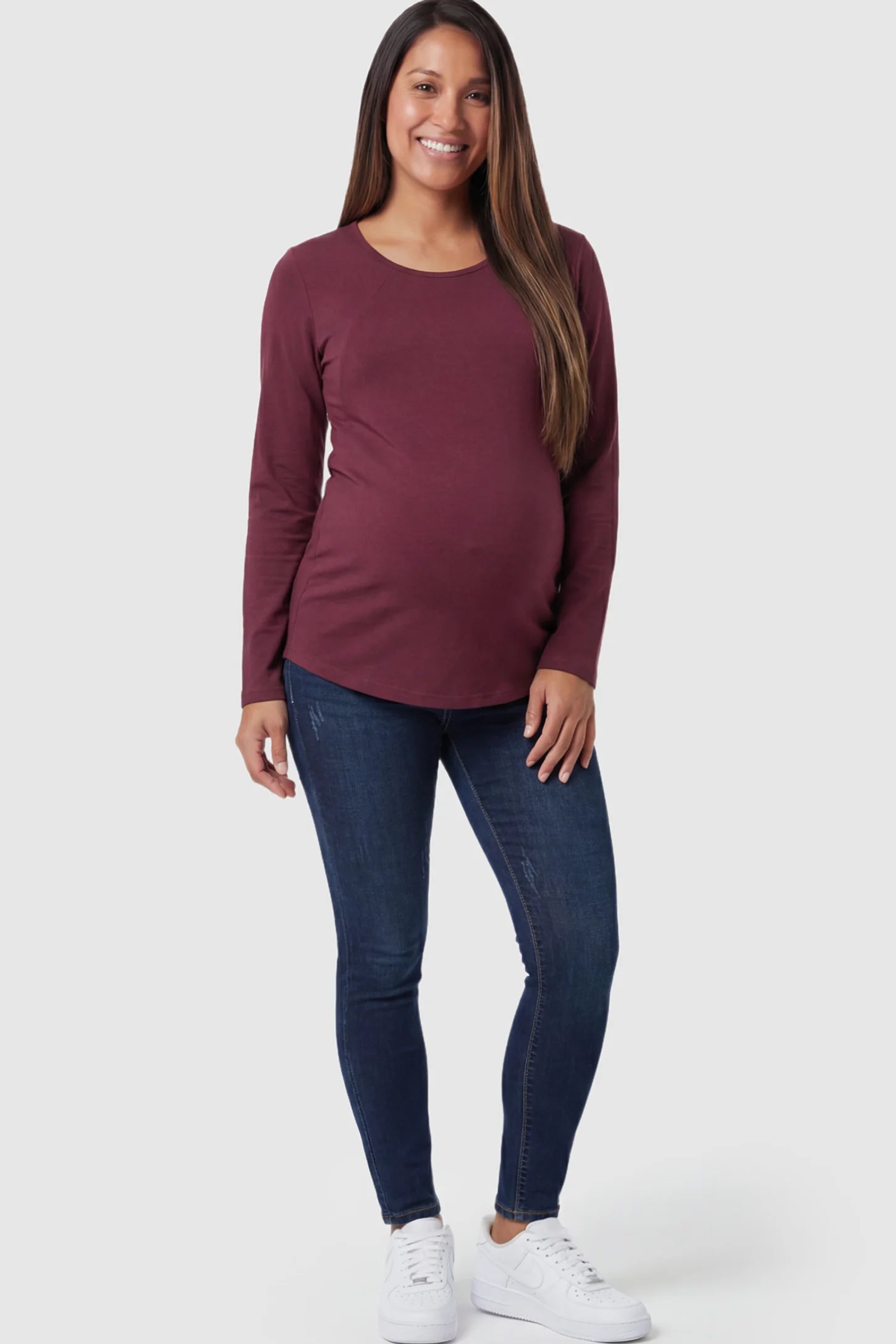 Solid Crew Neck Long Sleeve Maternity & Nursing Top Solid Crew Neck Long Sleeve Maternity & Nursing Top in Wine Red featuring a discreet lift-up breastfeeding access on a model.