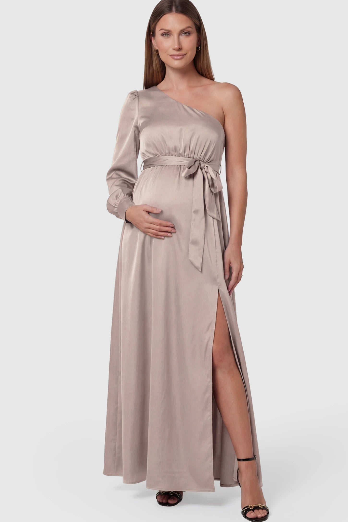Satin One Shoulder Belted Maternity Maxi Dress Satin One-Shoulder Belted Maternity Maxi Dress in Light gray featuring a side slit and waist tie on a pregnant model.