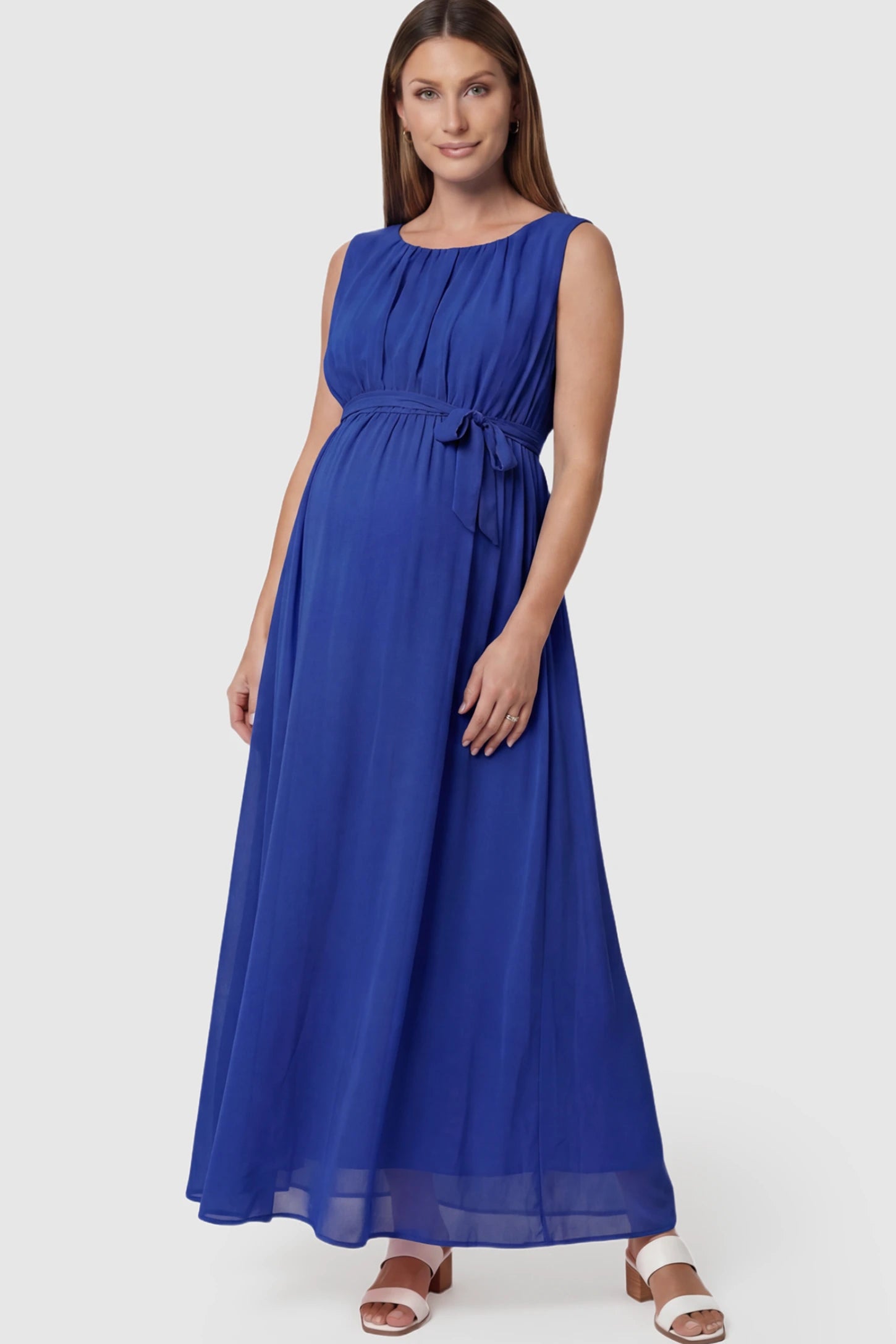 Empire Waist Tie-Front Sleeveless Maternity Maxi Dress in Blue featuring a tie front and empire waist on a pregnant model.