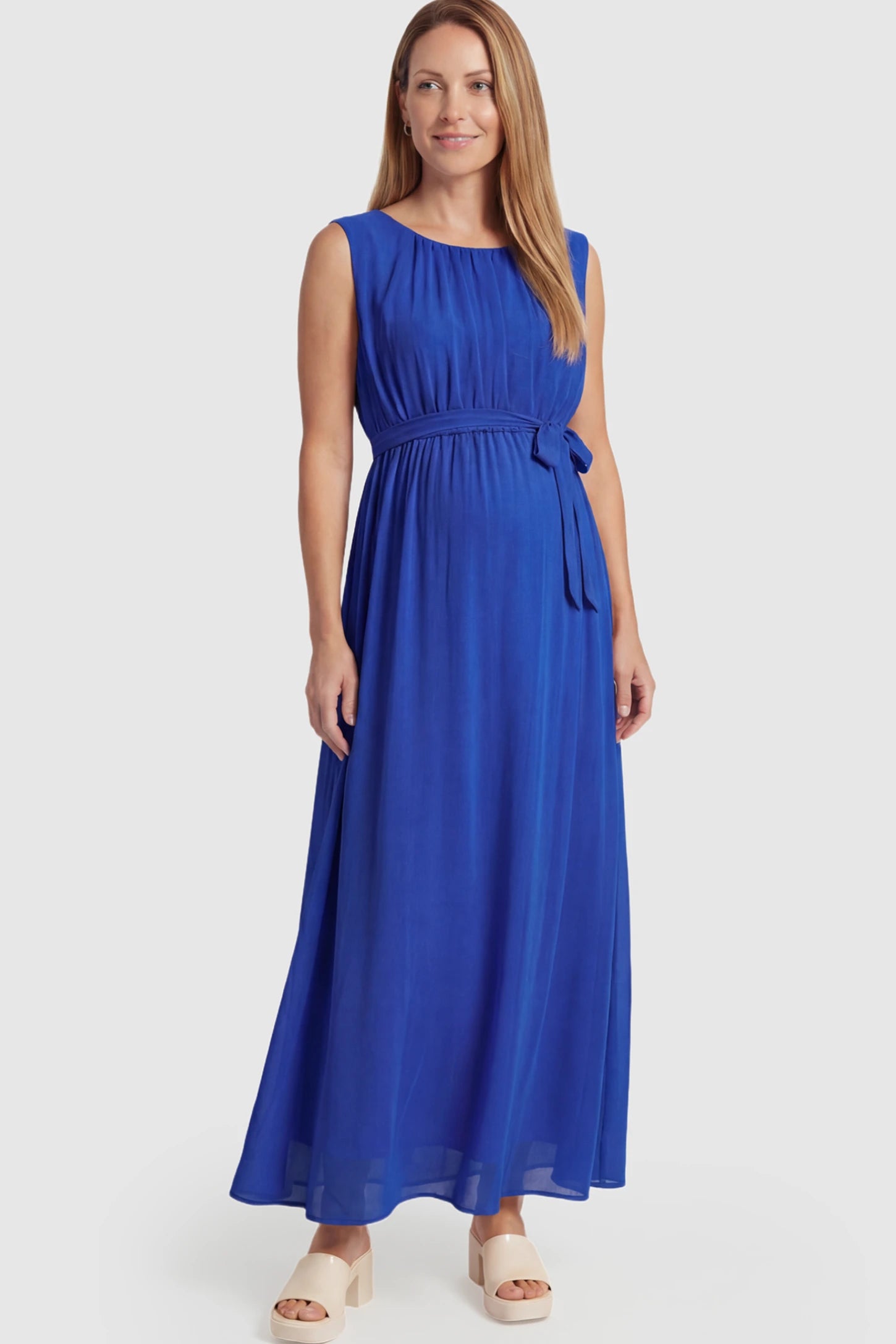 Empire Waist Tie-Front Sleeveless Maternity Maxi Dress Empire Waist Tie-Front Sleeveless Maternity Maxi Dress in Blue featuring a tie front and empire waist on a postpartum model.