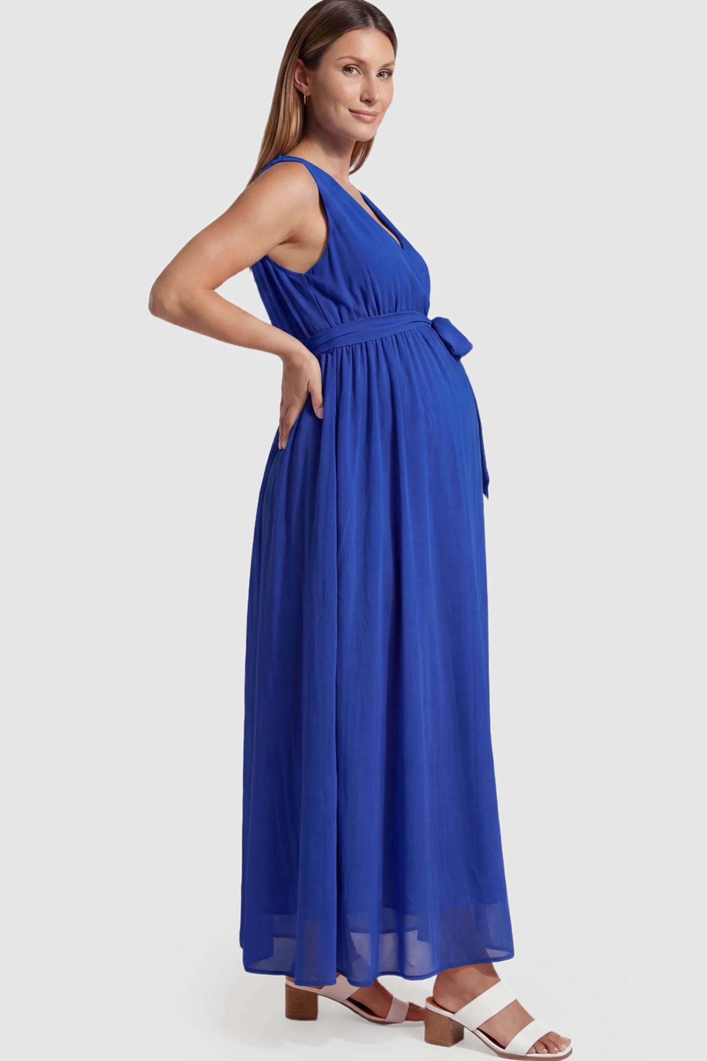 Empire Waist Tie-Front Sleeveless Maternity Maxi Dress in Blue featuring a tie front and empire waist on a pregnant model.