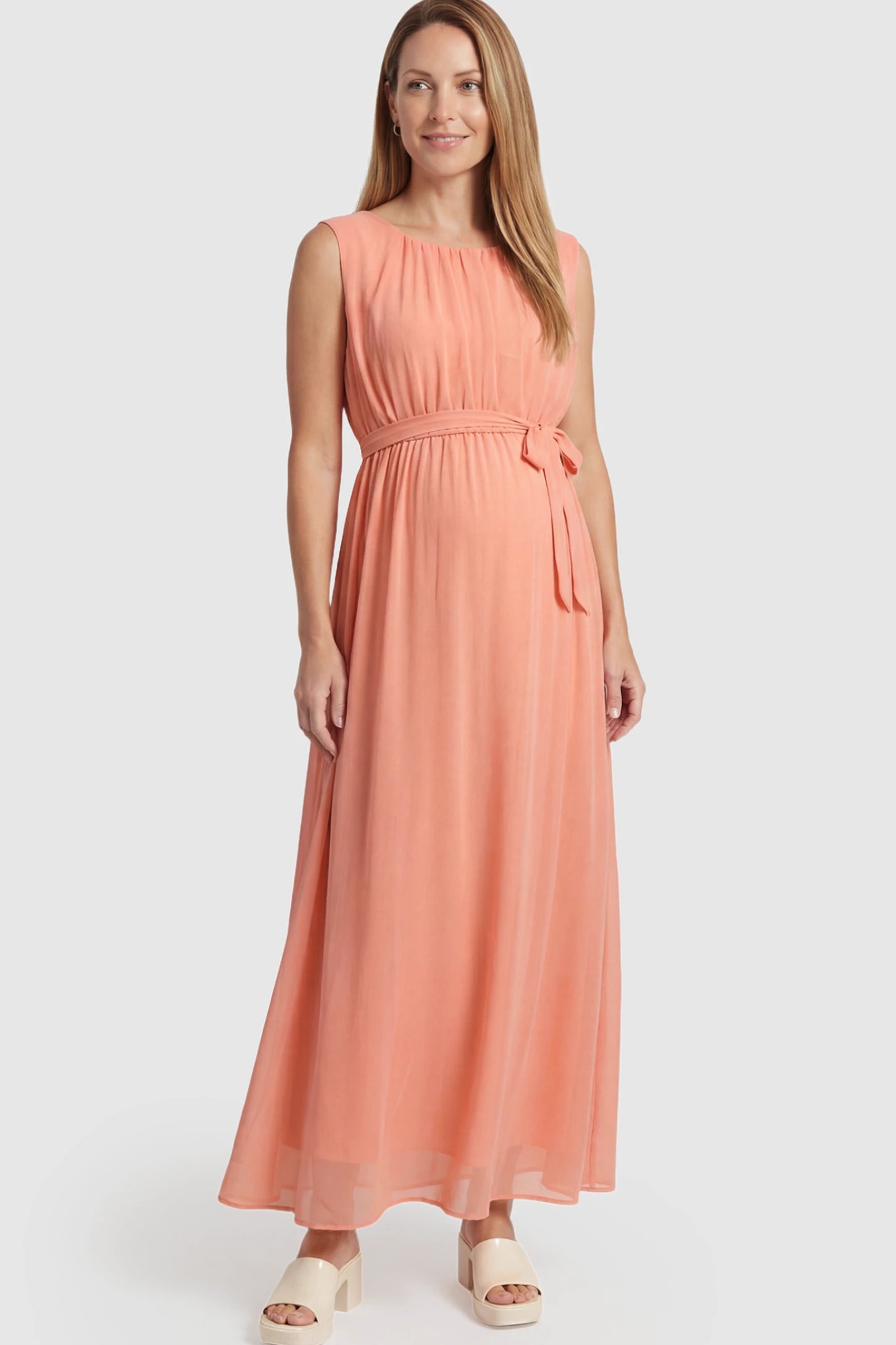 Empire Waist Tie-Front Sleeveless Maternity Maxi Dress Empire Waist Tie-Front Sleeveless Maternity Maxi Dress in Pink featuring a tie front and empire waist on a postpartum model.