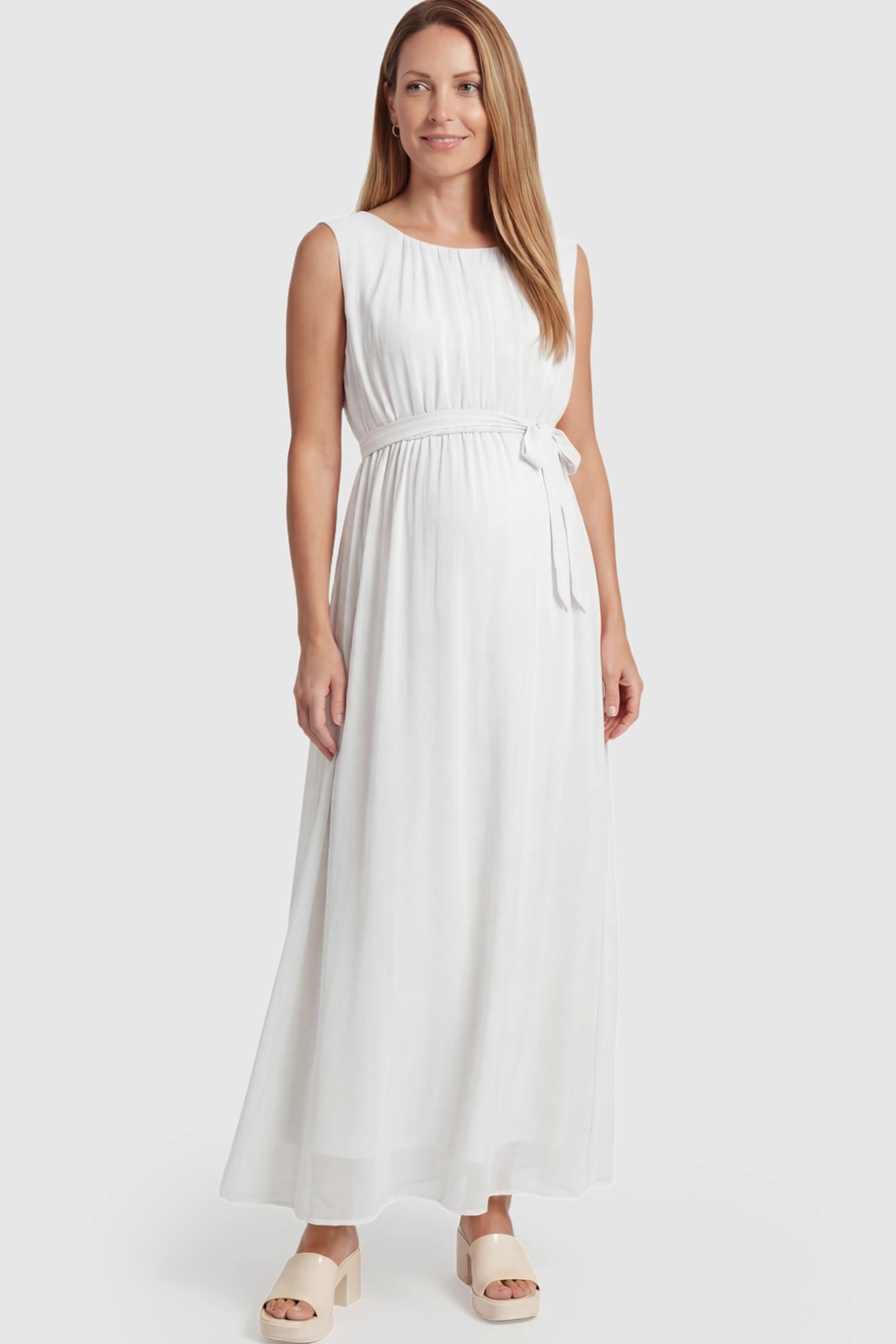 Empire Waist Tie-Front Sleeveless Maternity Maxi Dress Empire Waist Tie-Front Sleeveless Maternity Maxi Dress in White featuring a tie front and empire waist on a postpartum model.