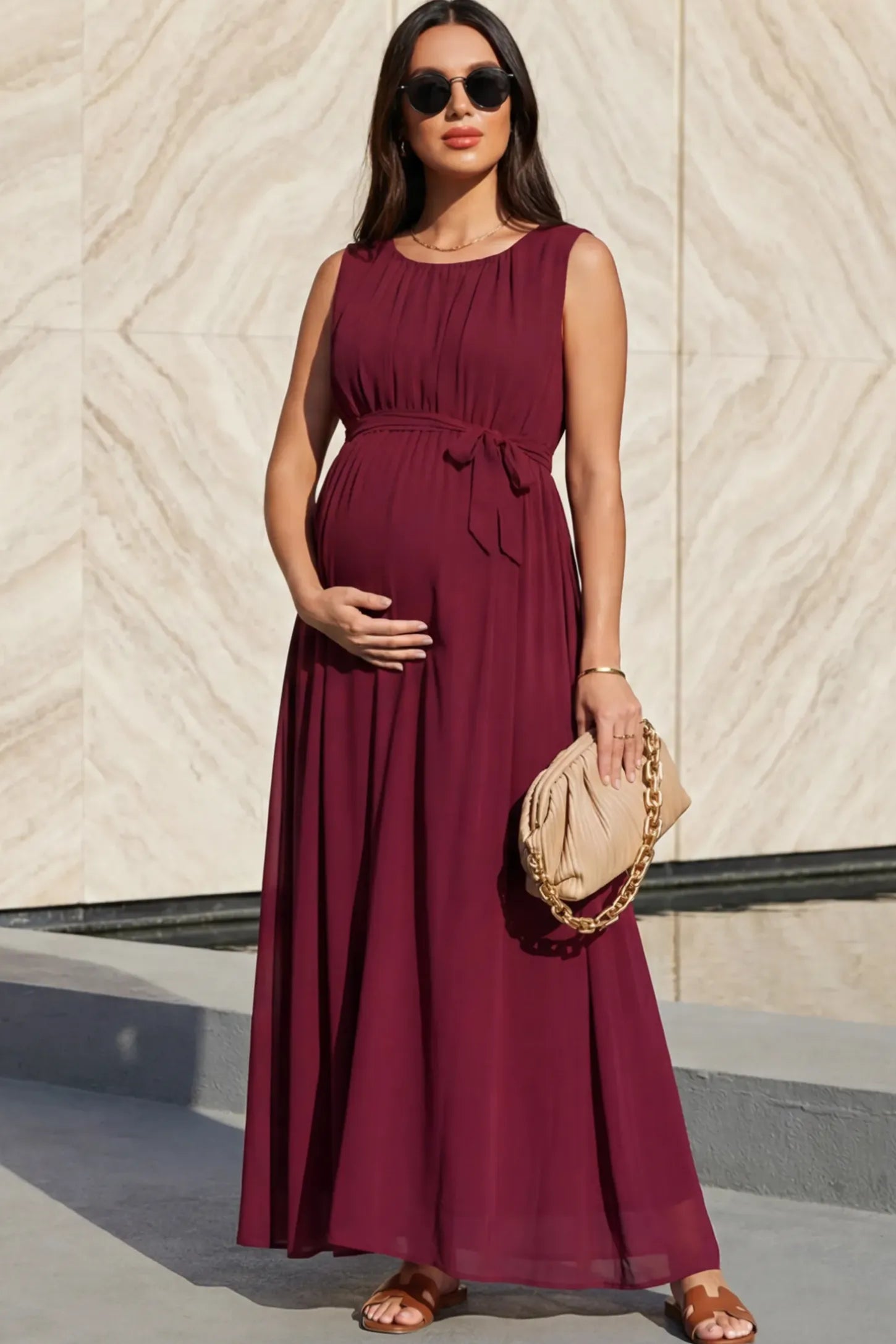 Empire Waist Tie-Front Sleeveless Maternity Maxi Dress Empire Waist Tie-Front Sleeveless Maternity Maxi Dress in Wine Red featuring a tie front and empire waist on a pregnant model.