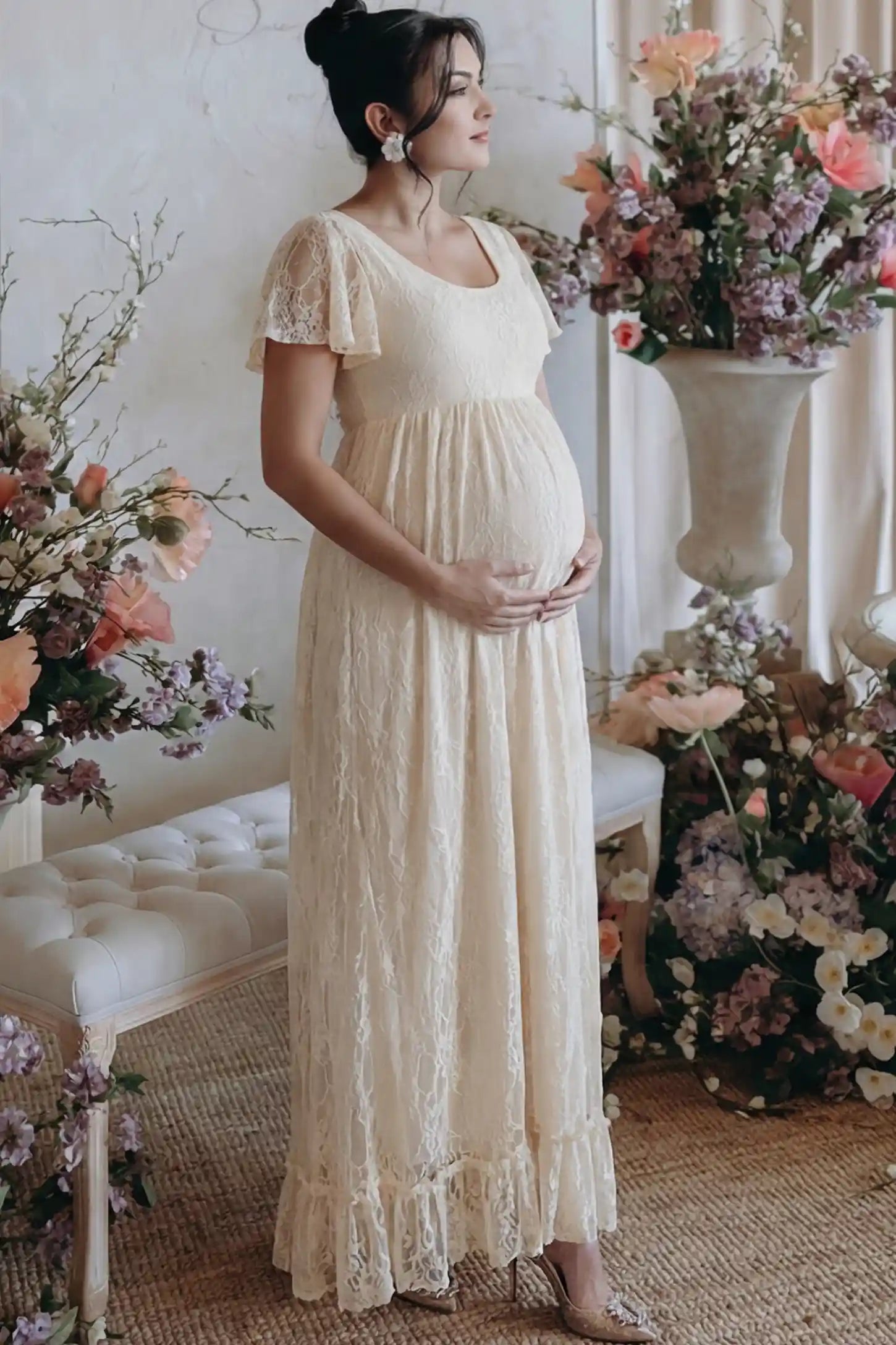 Floral Lace Flutter Sleeve Maternity Maxi Dress Floral Lace Flutter Sleeve Maxi Maternity Dress in Beige featuring delicate lace and an empire waist on a pregnant model.