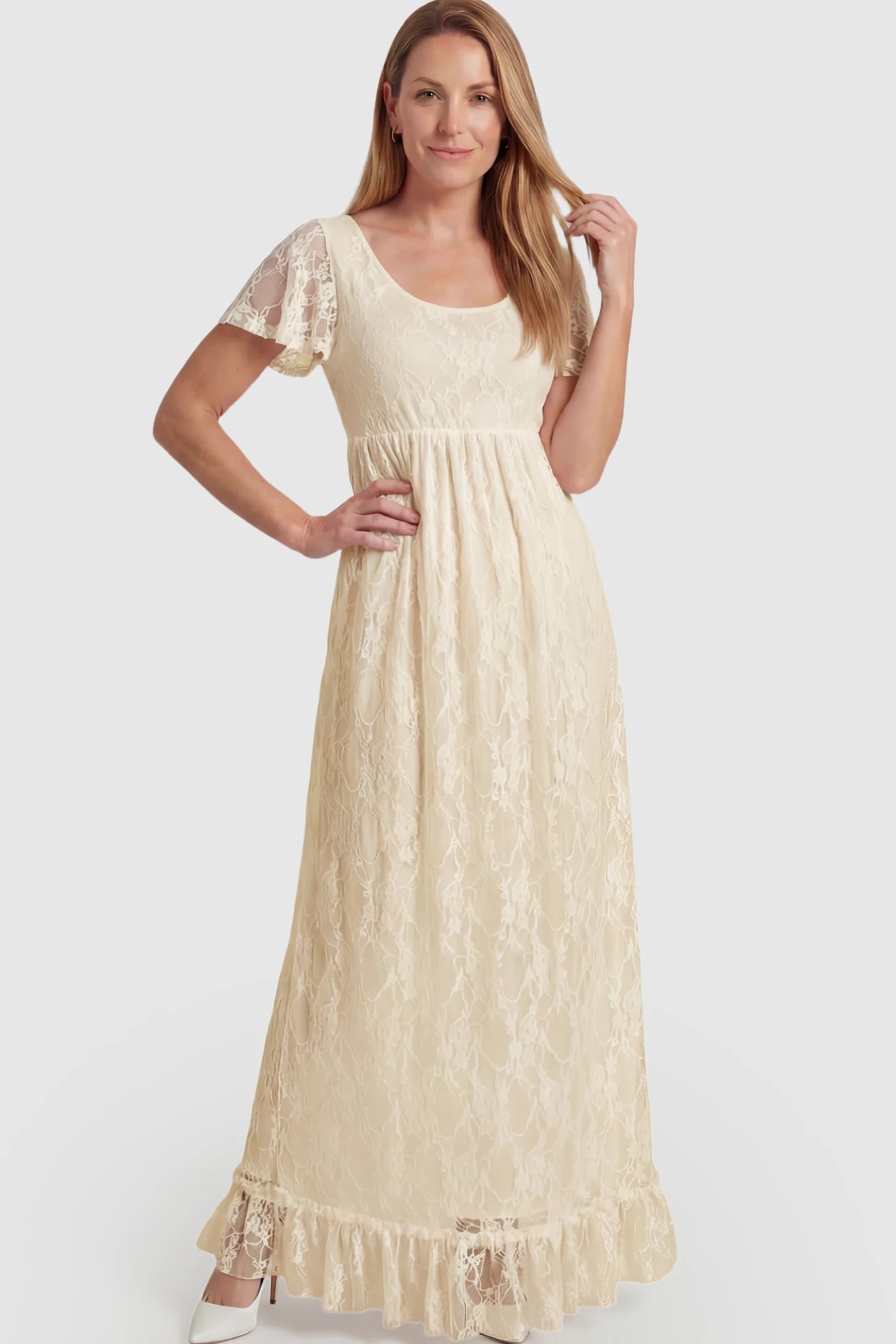 Floral Lace Flutter Sleeve Maternity Maxi Dress Floral Lace Flutter Sleeve Maxi Maternity Dress in Beige featuring delicate lace and an empire waist on a postpartum model.