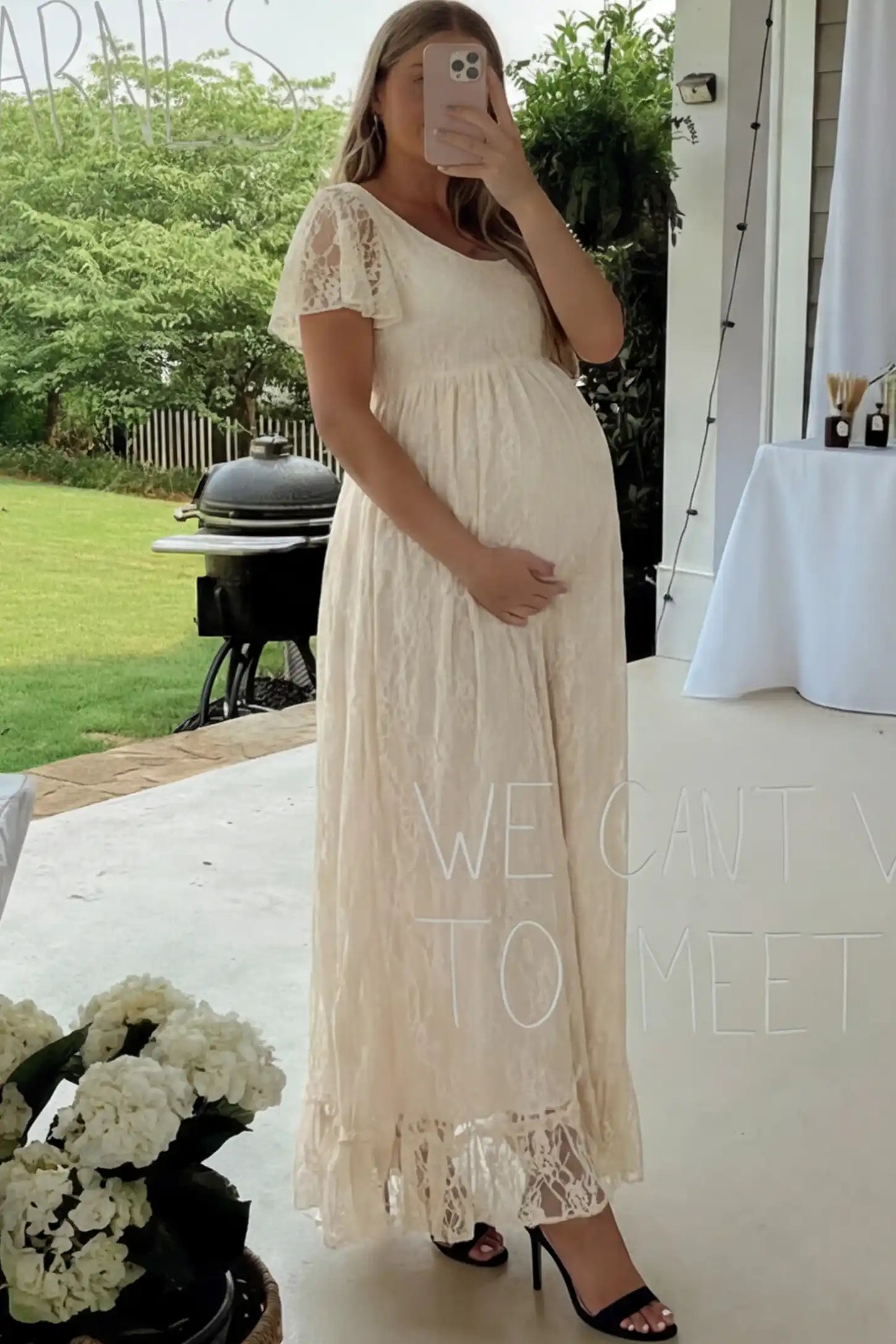 Floral Lace Flutter Sleeve Maternity Maxi Dress Floral Lace Flutter Sleeve Maxi Maternity Dress in Beige featuring delicate lace and an empire waist on a pregnant model.
