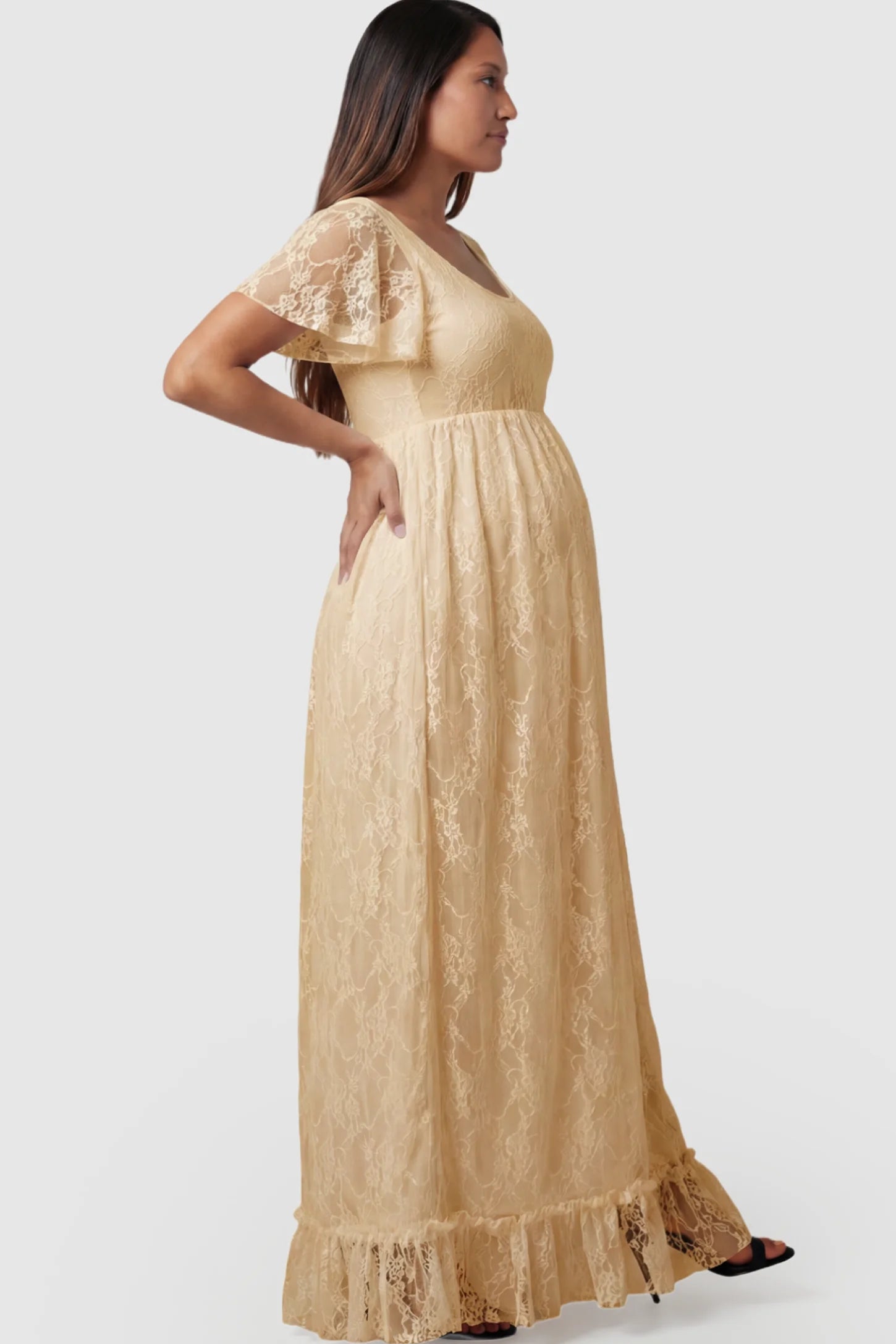 Floral Lace Flutter Sleeve Maxi Maternity Dress in Champagne featuring delicate lace and an empire waist on a pregnant model.