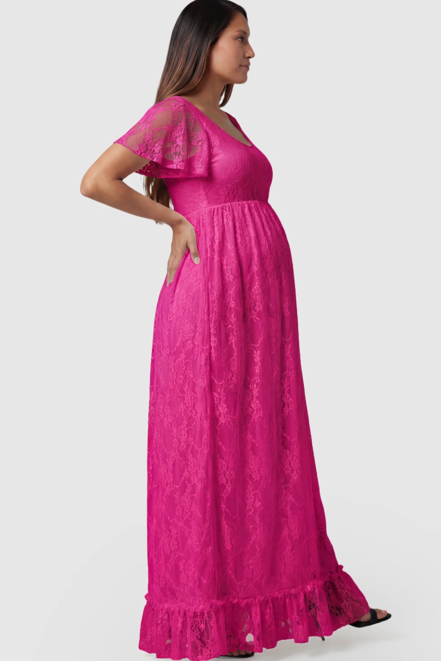 Floral Lace Flutter Sleeve Maternity Maxi Dress Floral Lace Flutter Sleeve Maxi Maternity Dress in Hot Pink featuring delicate lace and an empire waist on a pregnant model.