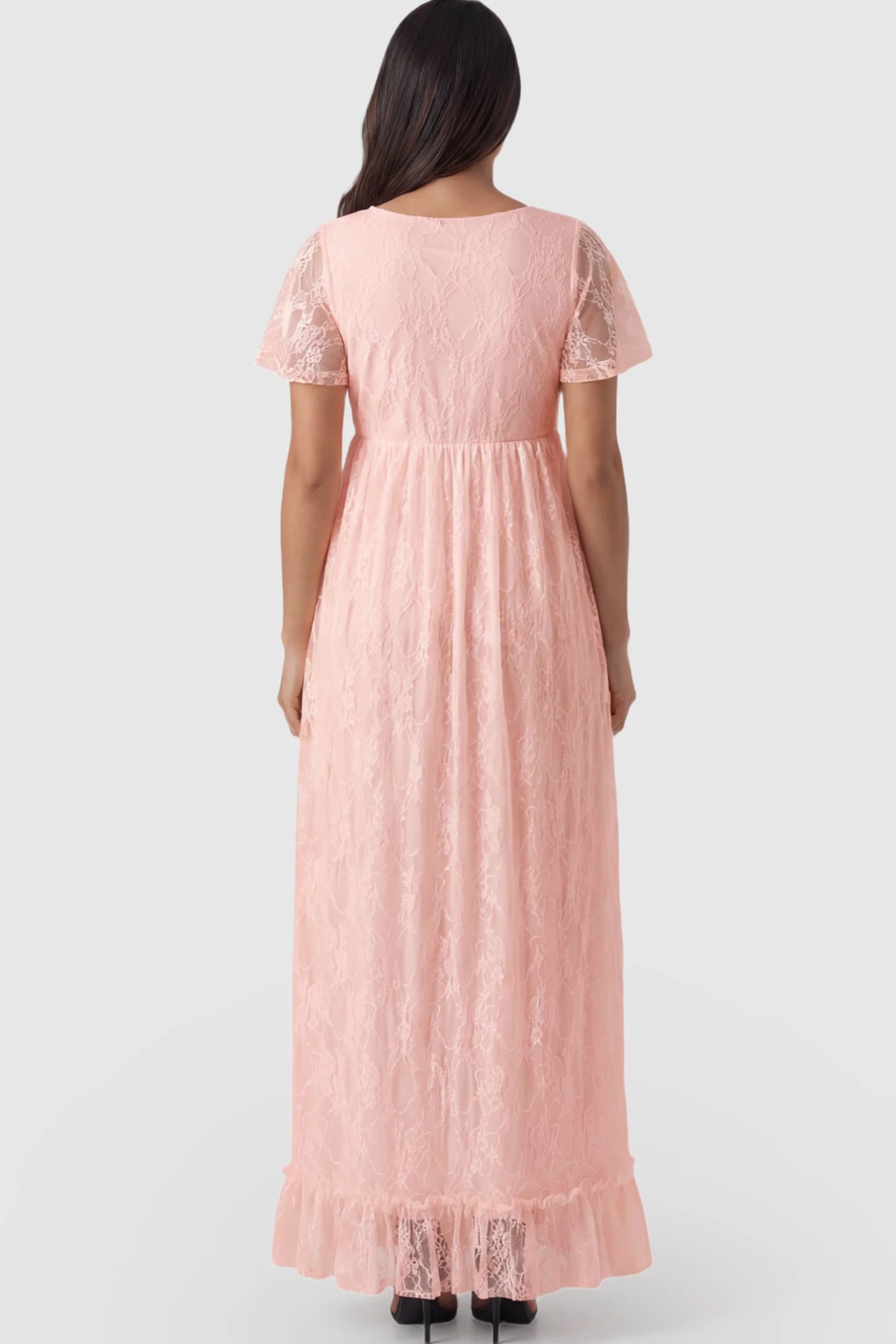 Floral Lace Flutter Sleeve Maternity Maxi Dress Floral Lace Flutter Sleeve Maxi Maternity Dress in Pink featuring delicate lace and an empire waist on a pregnant model.