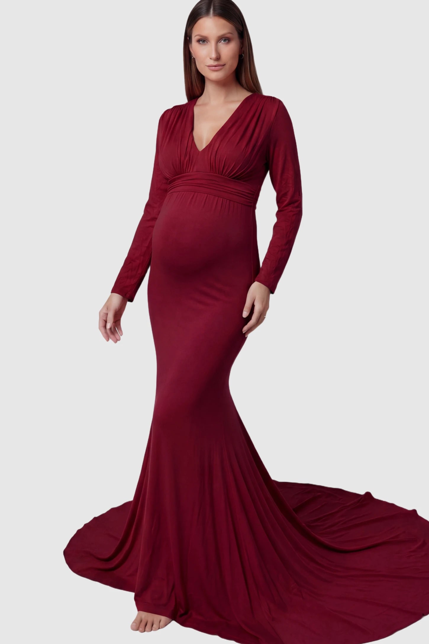 Pure Cotton V-Neck Long Sleeve Maternity Photoshoot Gown Pure Cotton V-Neck Long Sleeve Maternity Photoshoot Gown in Burgundy featuring a floor-pooling train on a pregnant model.