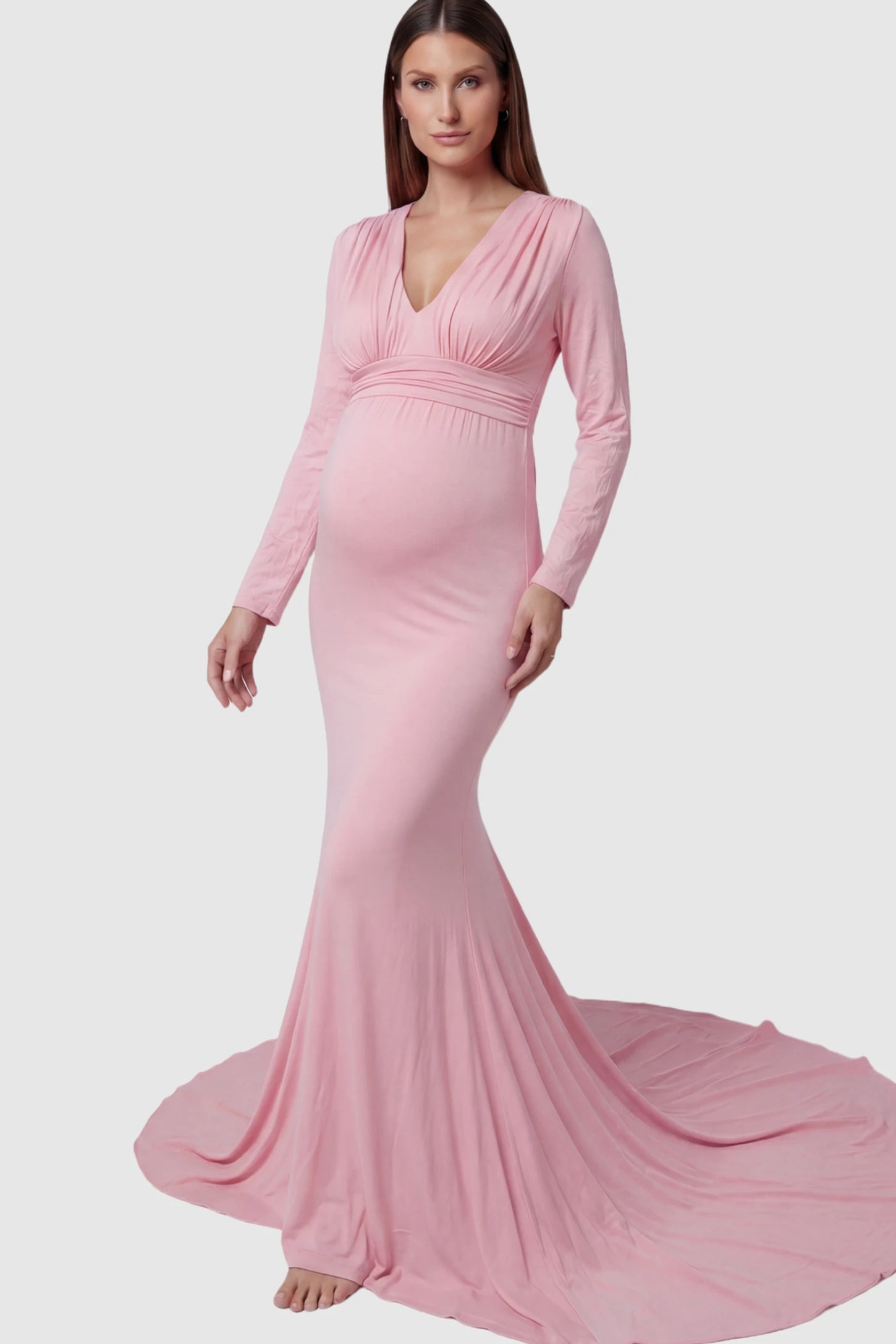 Pure Cotton V-Neck Long Sleeve Maternity Photoshoot Gown Pure Cotton V-Neck Long Sleeve Maternity Photoshoot Gown in Pink featuring a floor-pooling train on a pregnant model.