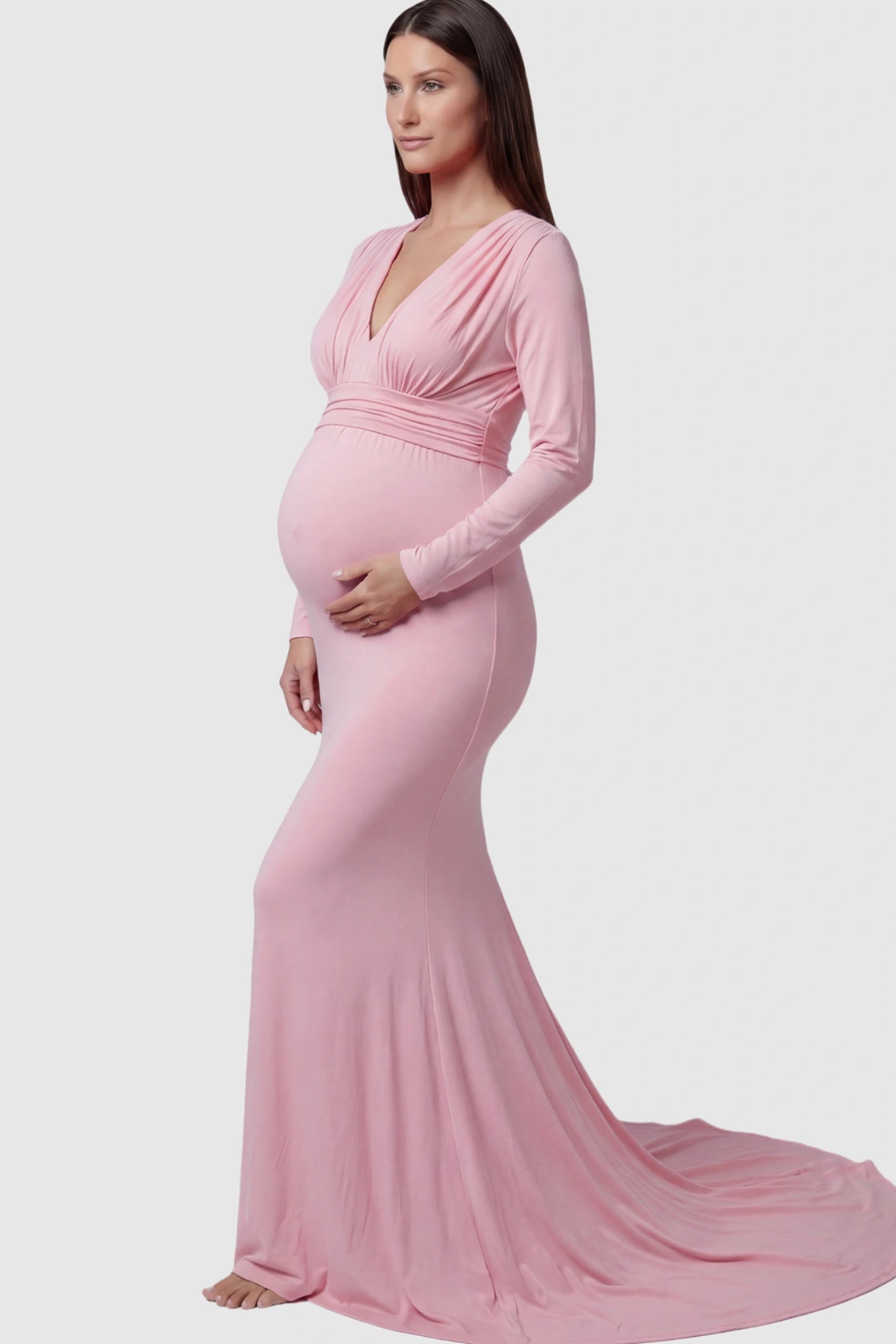 Pure Cotton V-Neck Long Sleeve Maternity Photoshoot Gown Pure Cotton V-Neck Long Sleeve Maternity Photoshoot Gown in Pink featuring a floor-pooling train on a pregnant model.