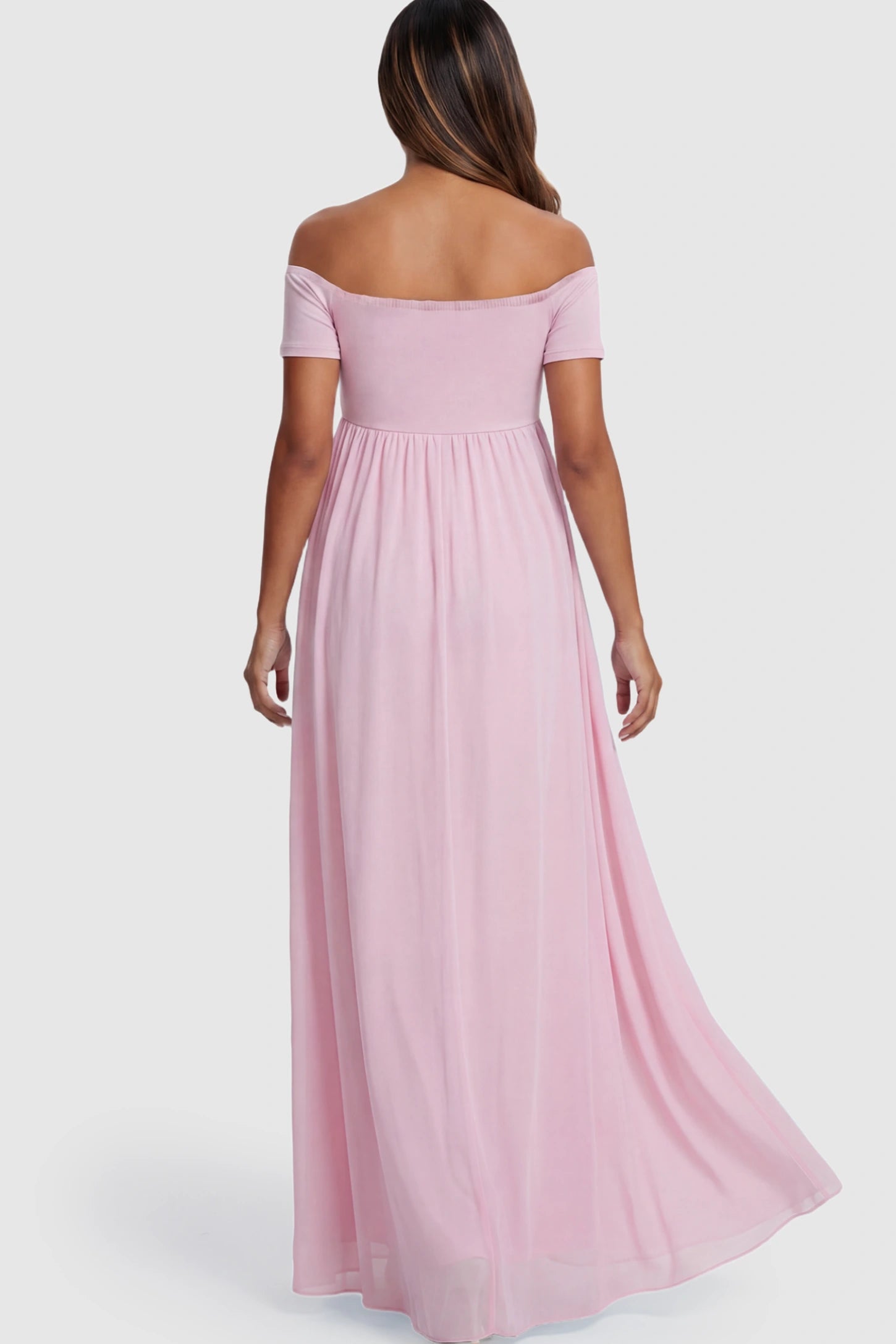 Solid Off Shoulder Flowy Maternity Maxi Dress Solid Off-the-Shoulder Sweetheart Maternity Maxi Dress in Pink on a pregnant model.