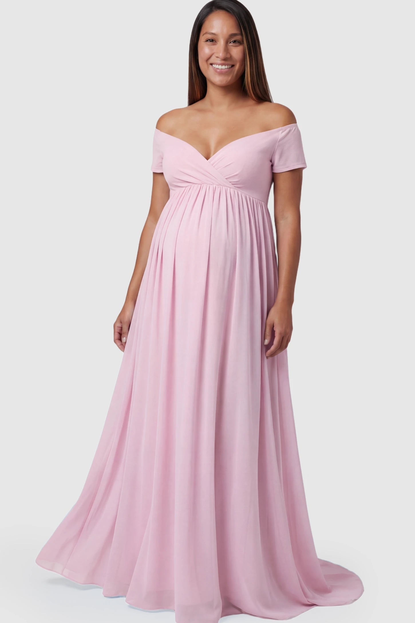Solid Off Shoulder Flowy Maternity Maxi Dress Solid Off-the-Shoulder Sweetheart Maternity Maxi Dress in Pink featuring an empire waist on a pregnant model.