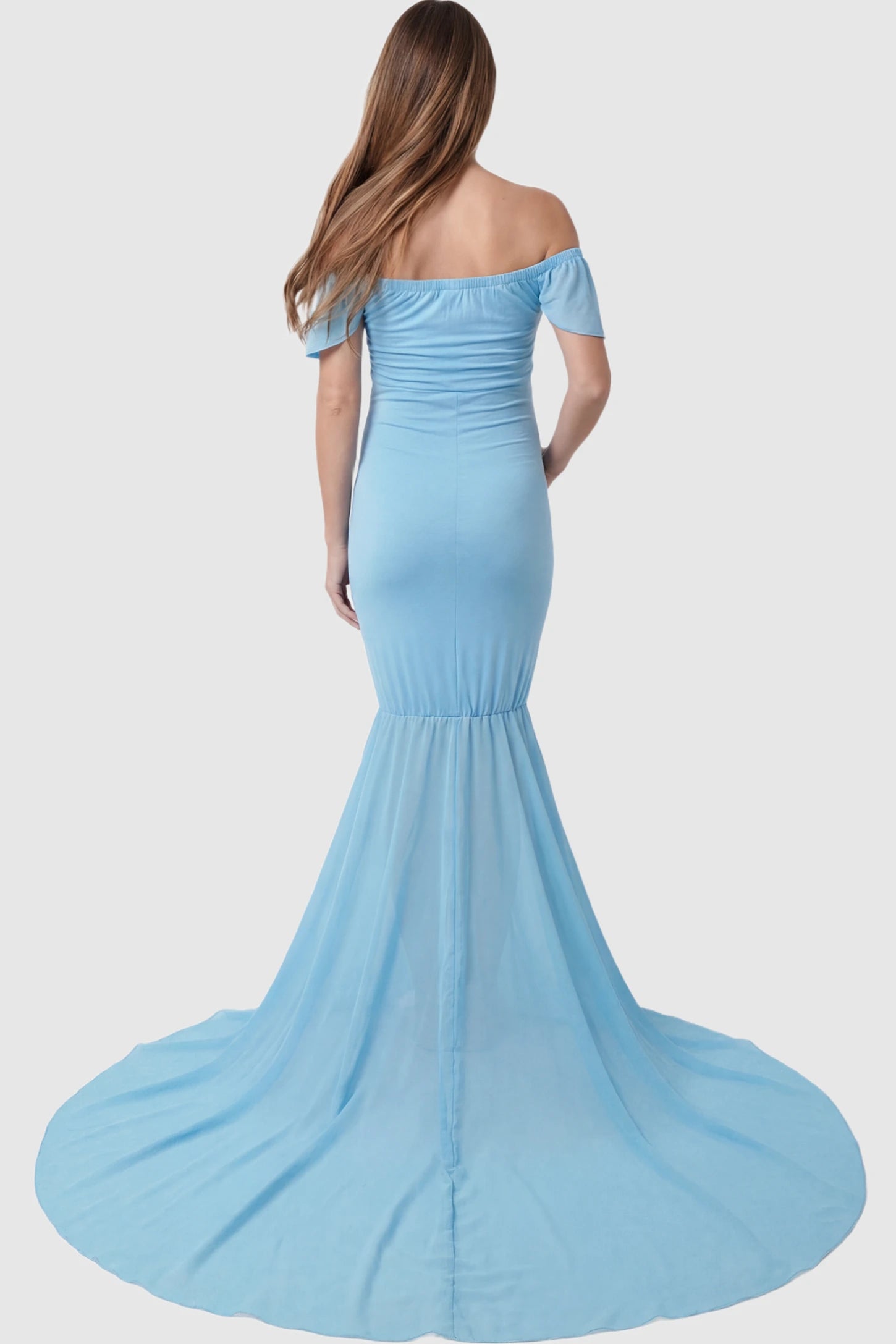 Solid Off Shoulder Fitted Maternity Photoshoot Gown Solid Off Shoulder Fitted Maternity Photoshoot Gown in light blue featuring flowing chiffon train on a pregnant model.