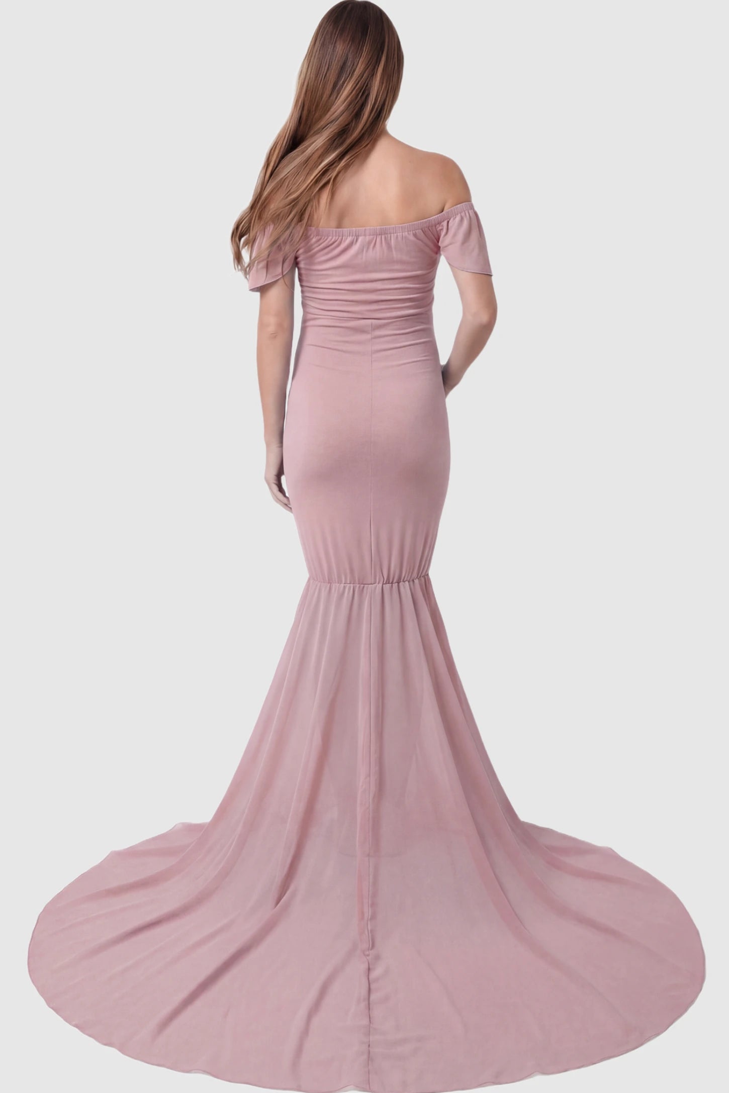 Solid Off Shoulder Fitted Maternity Photoshoot Gown Solid Off Shoulder Fitted Maternity Photoshoot Gown in pink featuring flowing chiffon train on a pregnant model.
