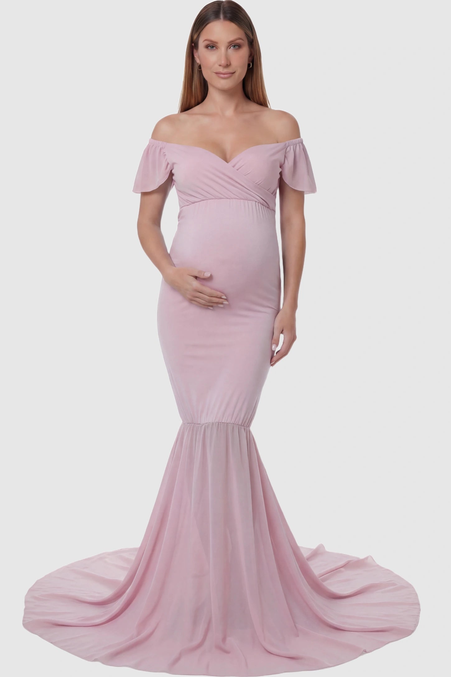 Solid Off Shoulder Fitted Maternity Photoshoot Gown Solid Off Shoulder Fitted Maternity Photoshoot Gown in pink featuring a sweetheart cross-front bodice and flowing chiffon train on a pregnant model.