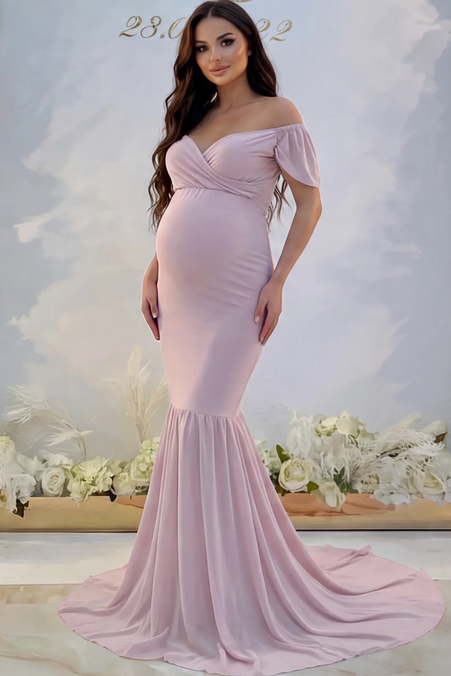Solid Off Shoulder Fitted Maternity Photoshoot Gown Solid Off Shoulder Fitted Maternity Photoshoot Gown in pink featuring a sweetheart cross-front bodice and flowing chiffon train on a pregnant model.