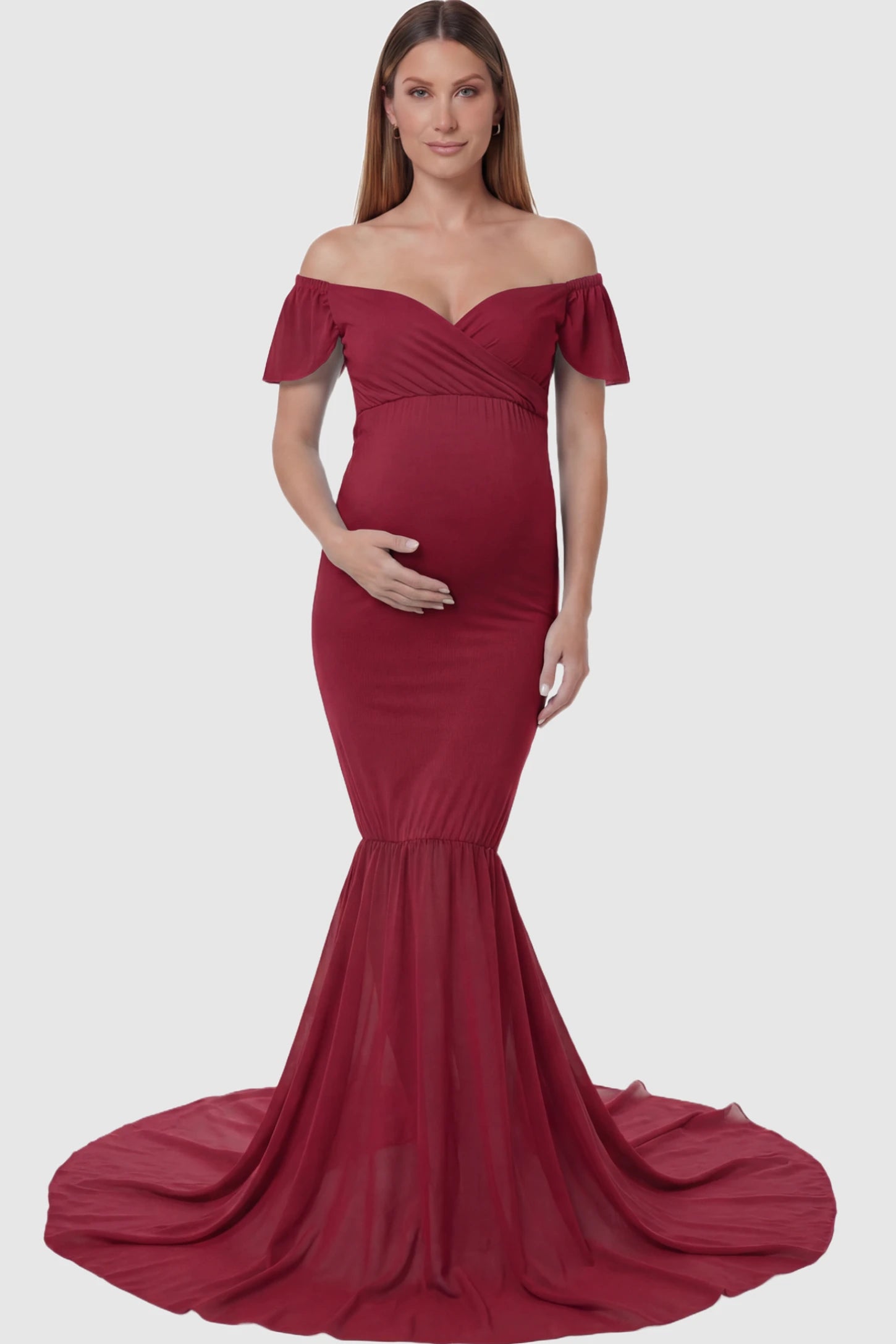 Solid Off Shoulder Fitted Maternity Photoshoot Gown Solid Off Shoulder Fitted Maternity Photoshoot Gown in red featuring a sweetheart cross-front bodice and flowing chiffon train on a pregnant model.