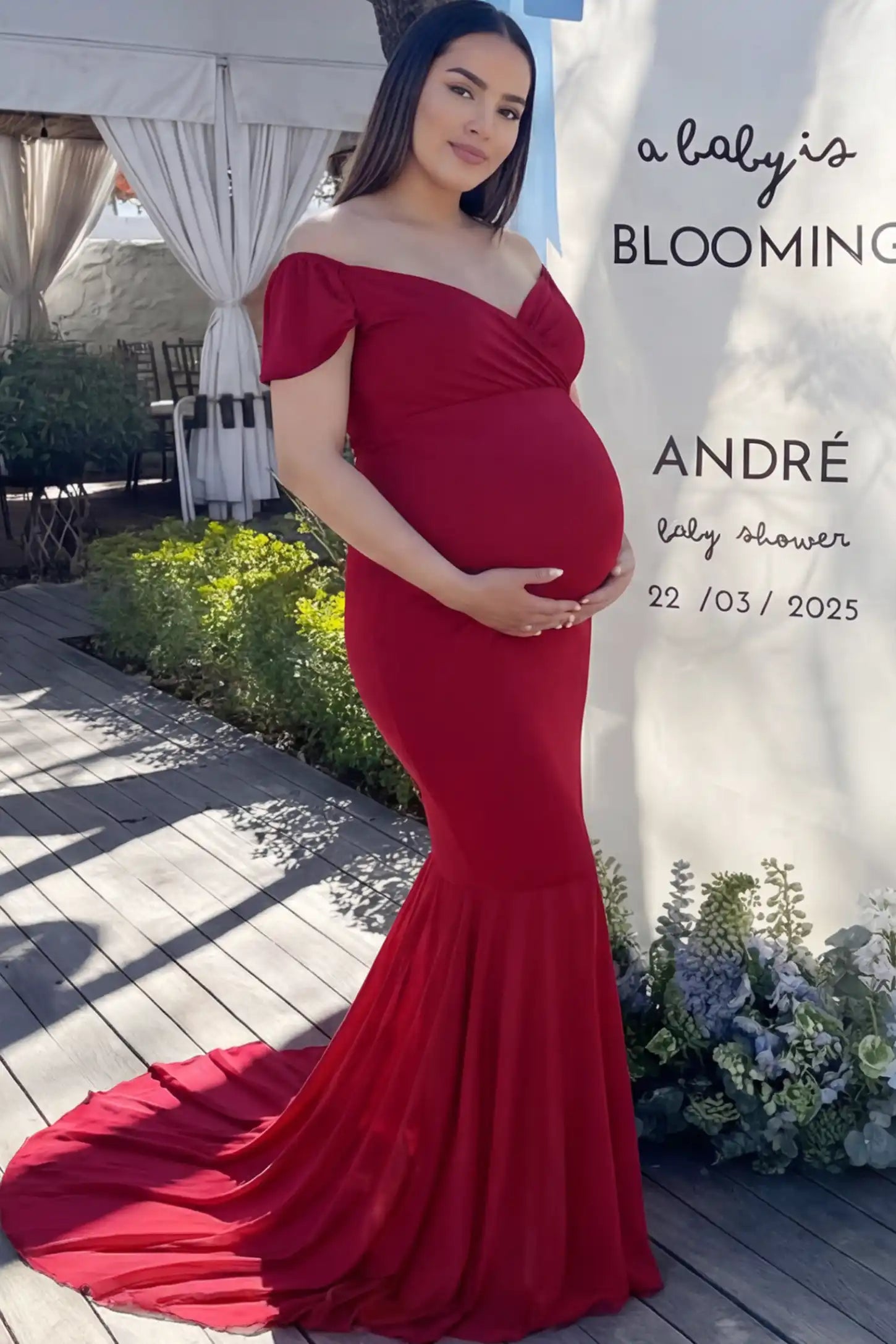 Solid Off Shoulder Fitted Maternity Photoshoot Gown Solid Off Shoulder Fitted Maternity Photoshoot Gown in red featuring a sweetheart cross-front bodice and flowing chiffon train on a pregnant model.