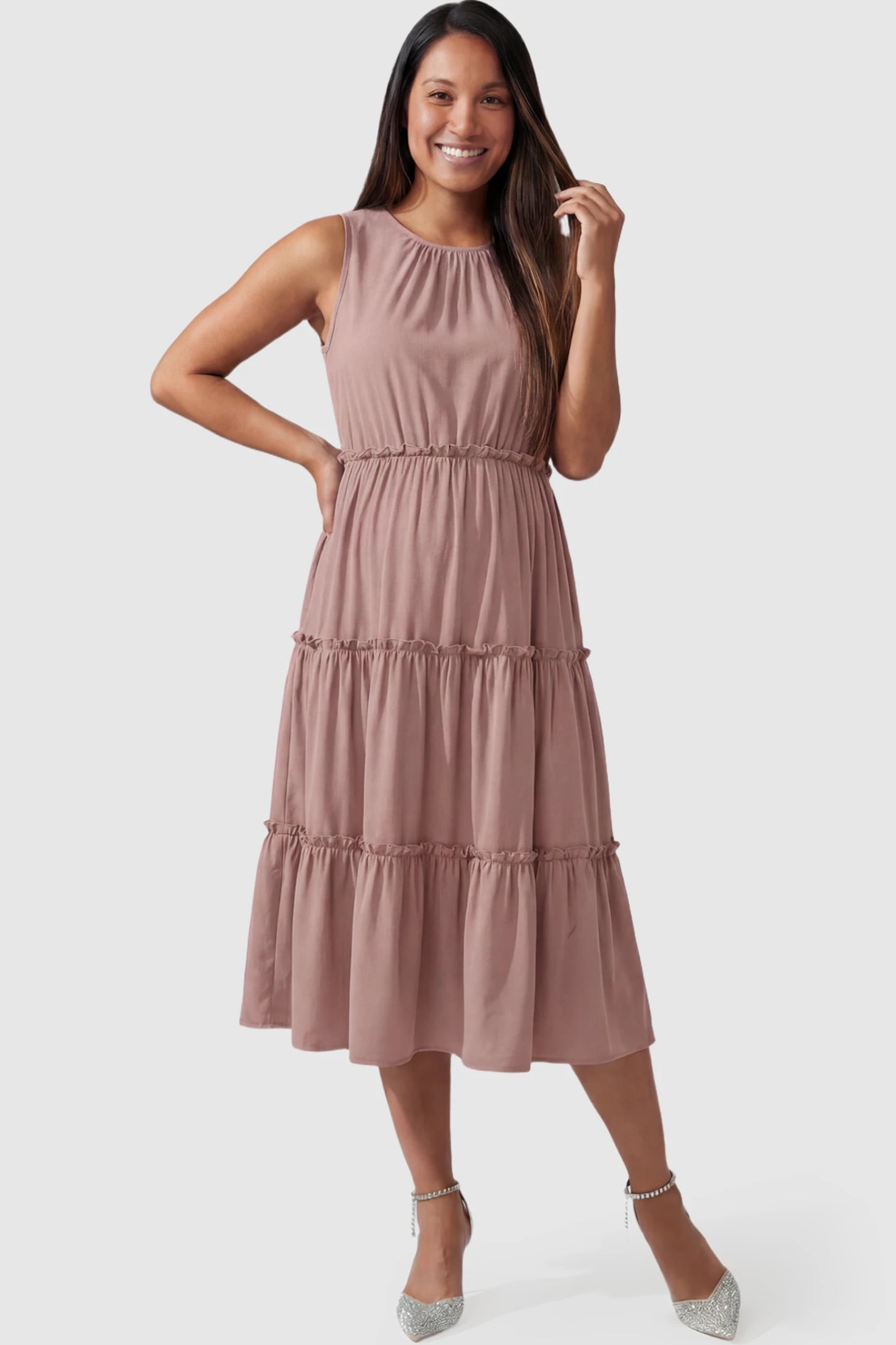 Solid Sleeveless Ruffle Tiered Maternity Midi Dress in Mauve featuring a ruffle tiered skirt on a pregnant model.