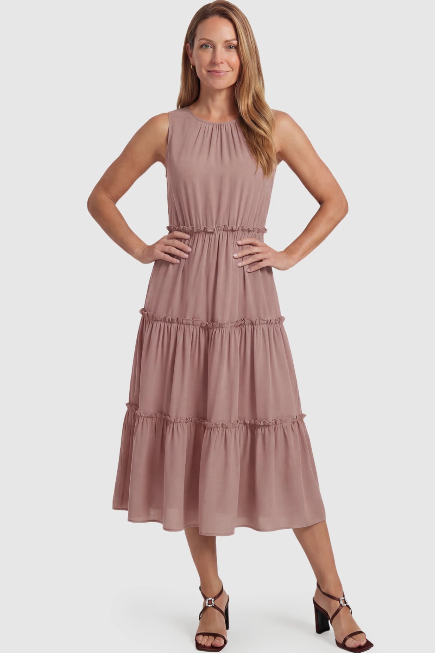 Solid Sleeveless Ruffle Tiered Maternity Midi Dress Solid Sleeveless Ruffle Tiered Maternity Midi Dress in Mauve featuring a ruffle tiered skirt on a postpartum model.