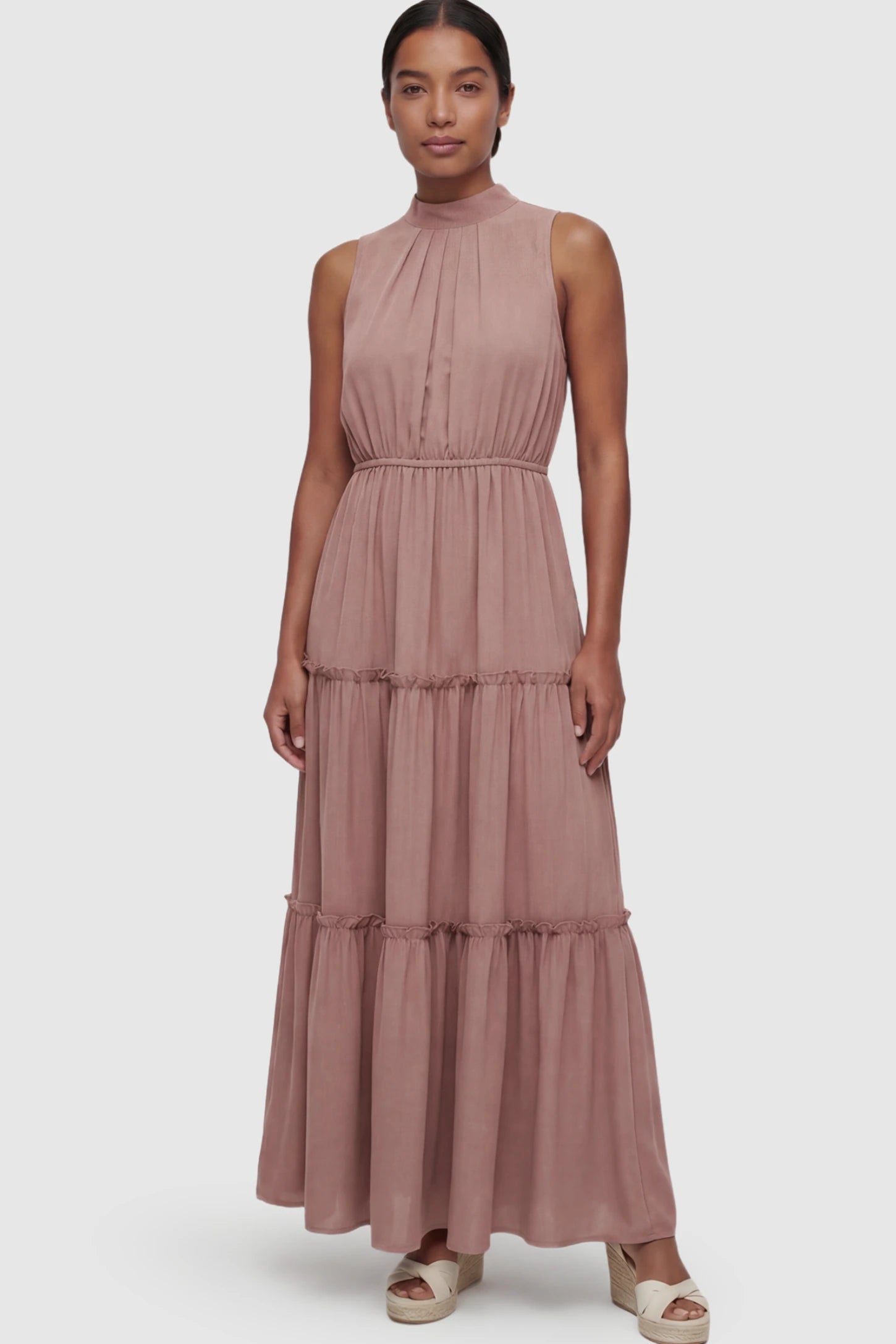Solid Sleeveless Ruffle Tiered Maternity Midi Dress Solid Sleeveless Ruffle Tiered Maternity Midi Dress in Mauve featuring a ruffle tiered skirt on a postpartum model.