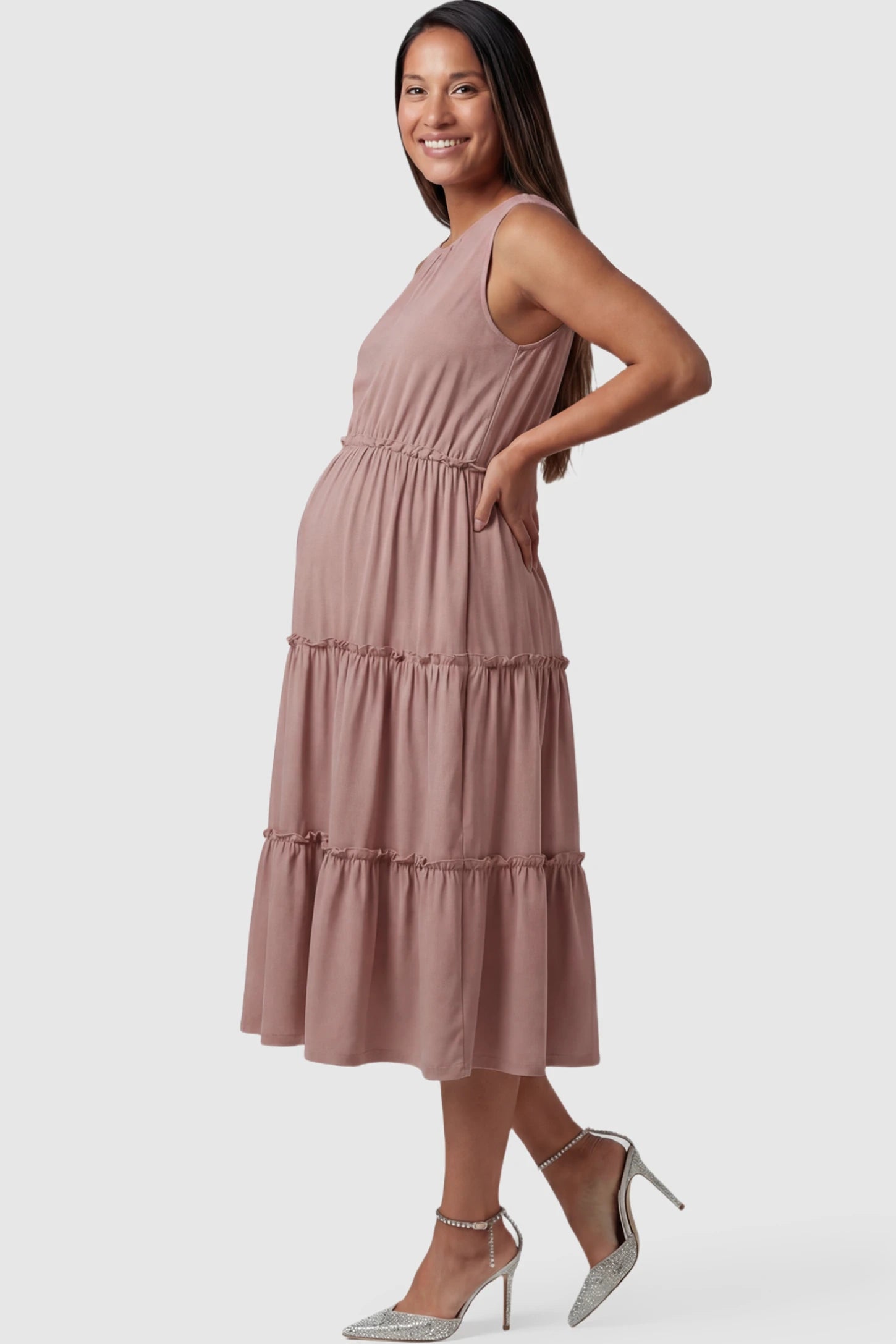 Solid Sleeveless Ruffle Tiered Maternity Midi Dress Solid Sleeveless Ruffle Tiered Maternity Midi Dress in Mauve featuring a ruffle tiered skirt on a pregnant model.
