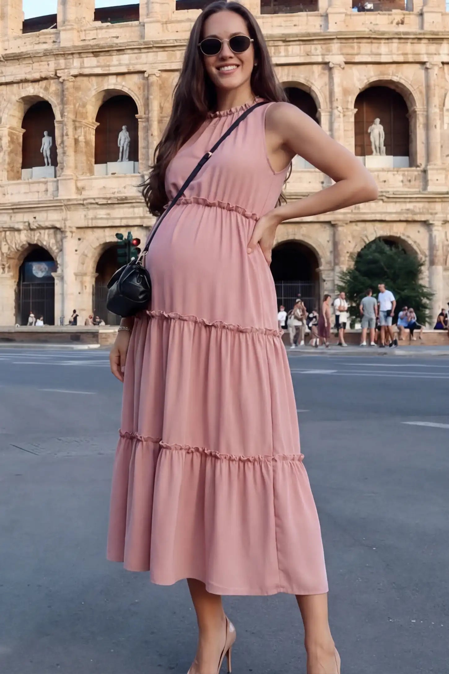 Solid Sleeveless Ruffle Tiered Maternity Midi Dress Solid Sleeveless Ruffle Tiered Maternity Midi Dress in Mauve featuring a ruffle tiered skirt on a pregnant model.