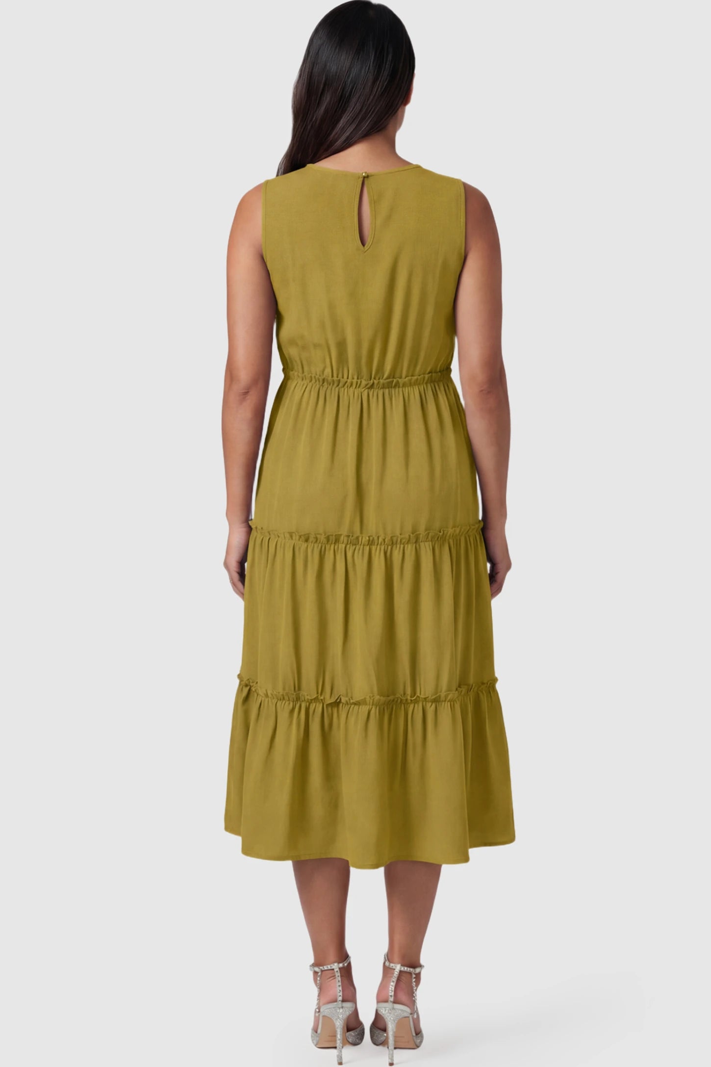 Solid Sleeveless Ruffle Tiered Maternity Midi Dress Solid Sleeveless Ruffle Tiered Maternity Midi Dress in olive green featuring a ruffle tiered skirt on a pregnant model.