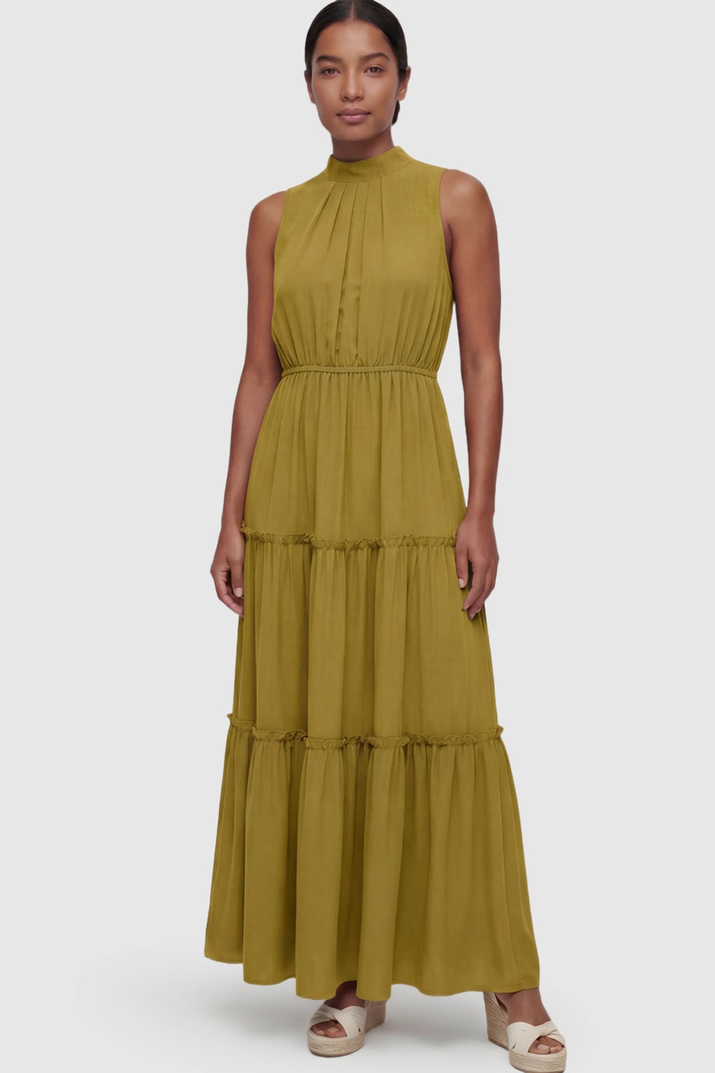 Solid Sleeveless Ruffle Tiered Maternity Midi Dress Solid Sleeveless Ruffle Tiered Maternity Midi Dress in Olive Green featuring a ruffle tiered skirt on a postpartum model.
