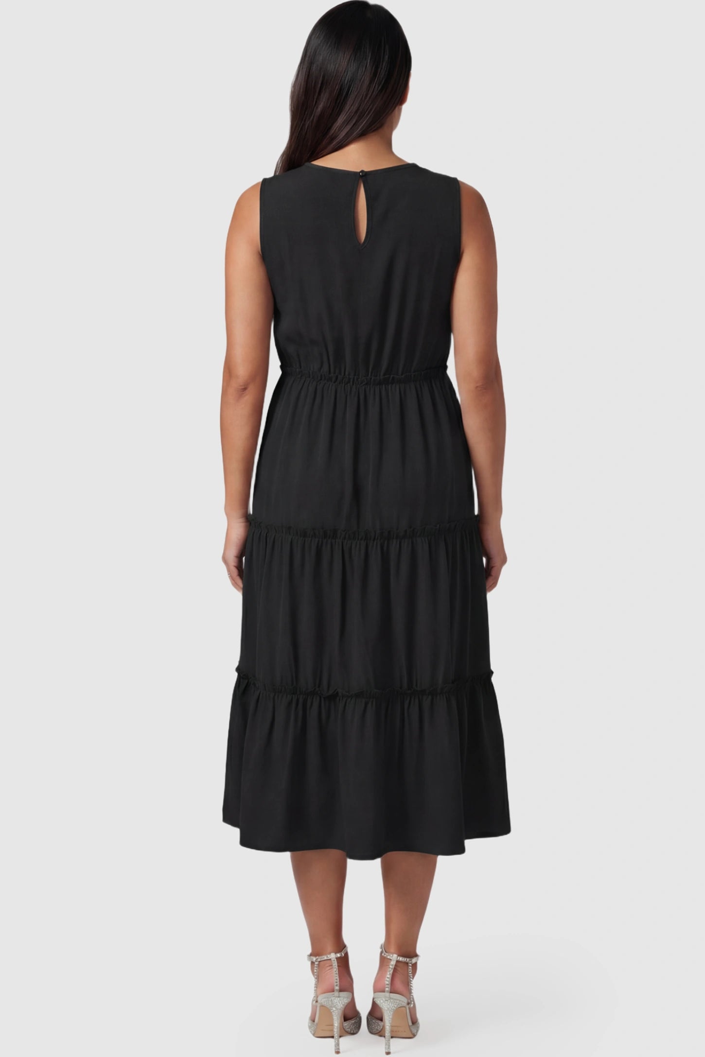 Solid Sleeveless Ruffle Tiered Maternity Midi Dress Solid Sleeveless Ruffle Tiered Maternity Midi Dress in black featuring a ruffle tiered skirt on a pregnant model.