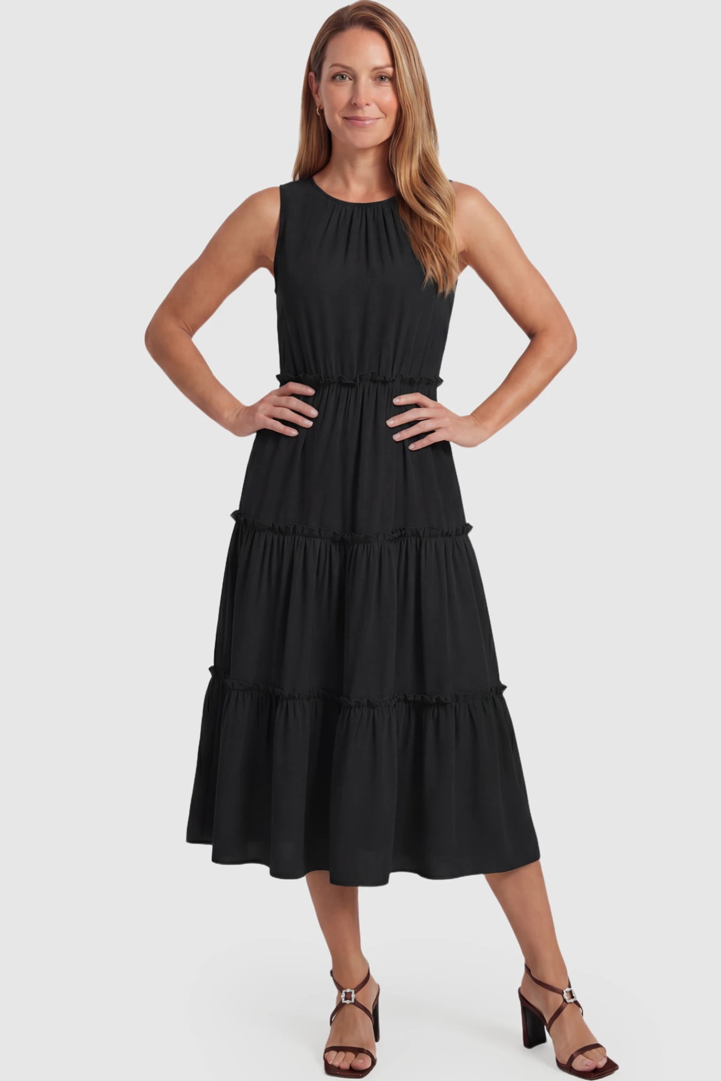 Solid Sleeveless Ruffle Tiered Maternity Midi Dress Solid Sleeveless Ruffle Tiered Maternity Midi Dress in black featuring a ruffle tiered skirt on a postpartum model.