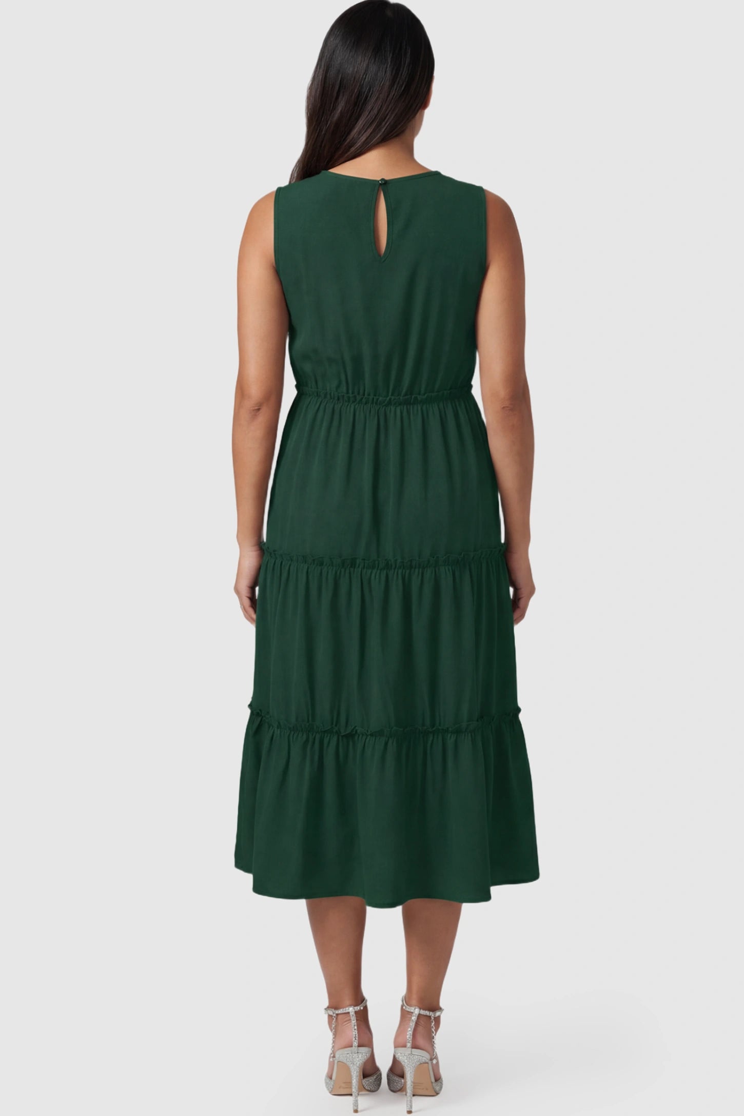 Solid Sleeveless Ruffle Tiered Maternity Midi Dress Solid Sleeveless Ruffle Tiered Maternity Midi Dress in dark green featuring a ruffle tiered skirt on a pregnant model.