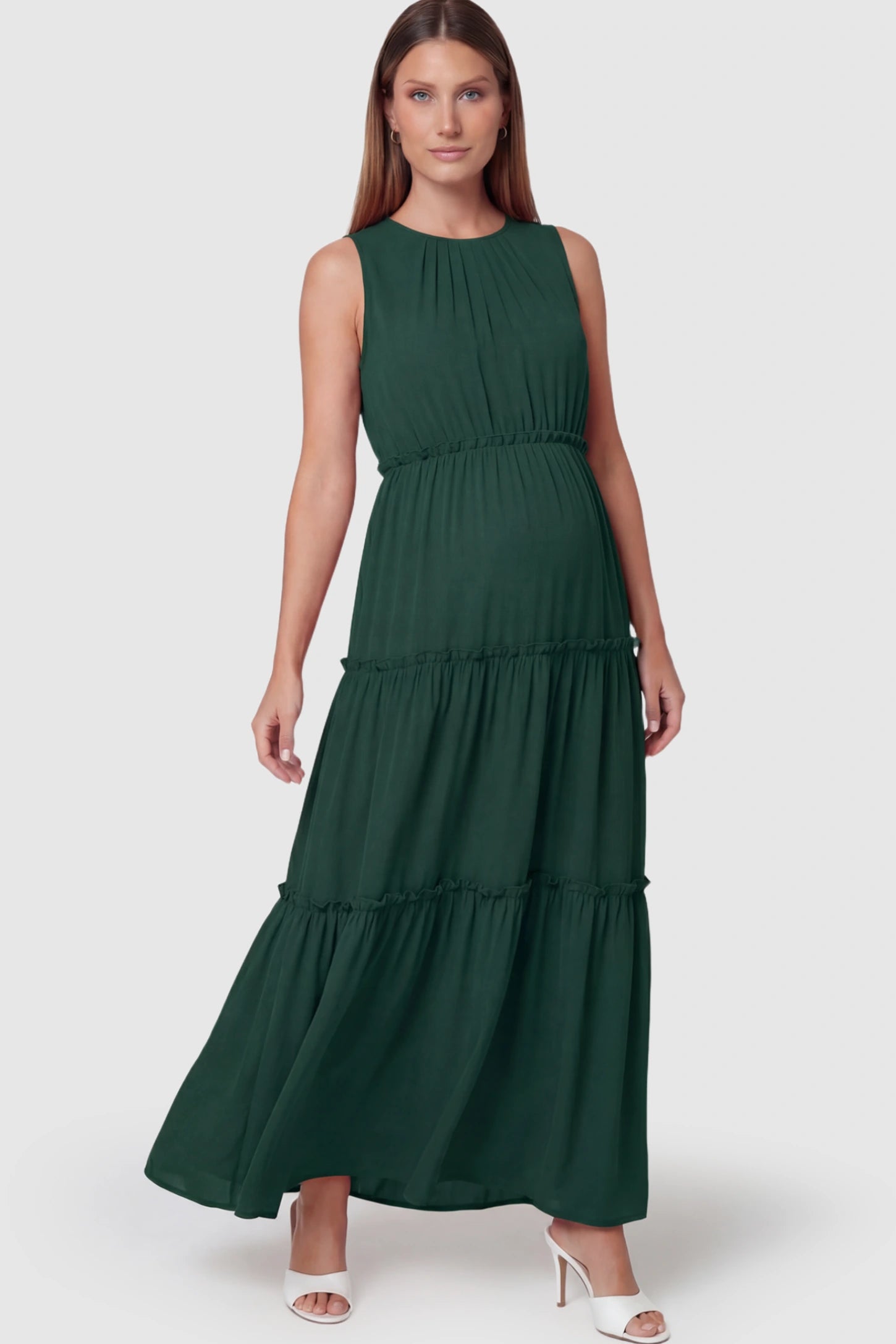 Solid Sleeveless Ruffle Tiered Maternity Midi Dress Solid Sleeveless Ruffle Tiered Maternity Midi Dress in Dark Green featuring a ruffle tiered skirt on a pregnant model.