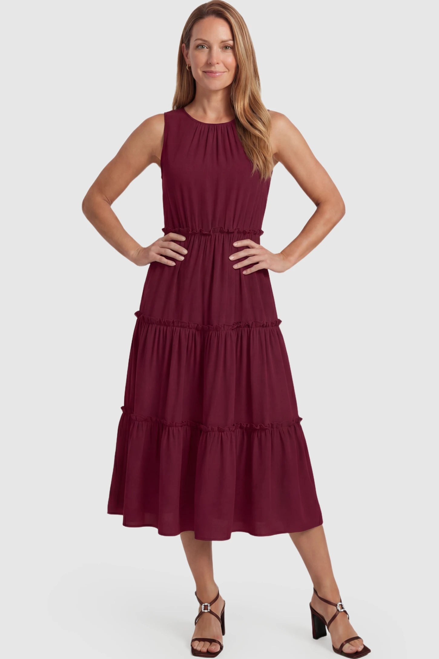 Solid Sleeveless Ruffle Tiered Maternity Midi Dress Solid Sleeveless Ruffle Tiered Maternity Midi Dress in wine red featuring a ruffle tiered skirt on a postpartum model.