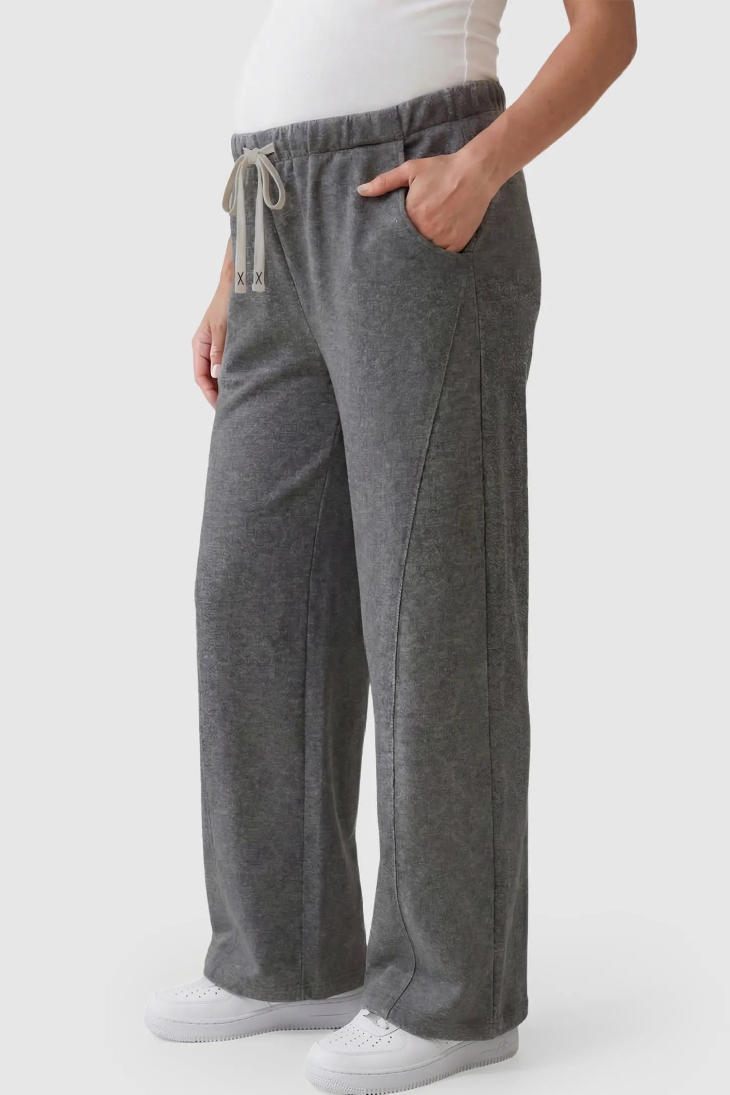 Drawstring Waist Wide Leg Maternity Lounge Pants Drawstring Waist Wide Leg Maternity Lounge Pants in Dark Gray featuring diagonal seam detailing and a relaxed silhouette on a pregnant model.