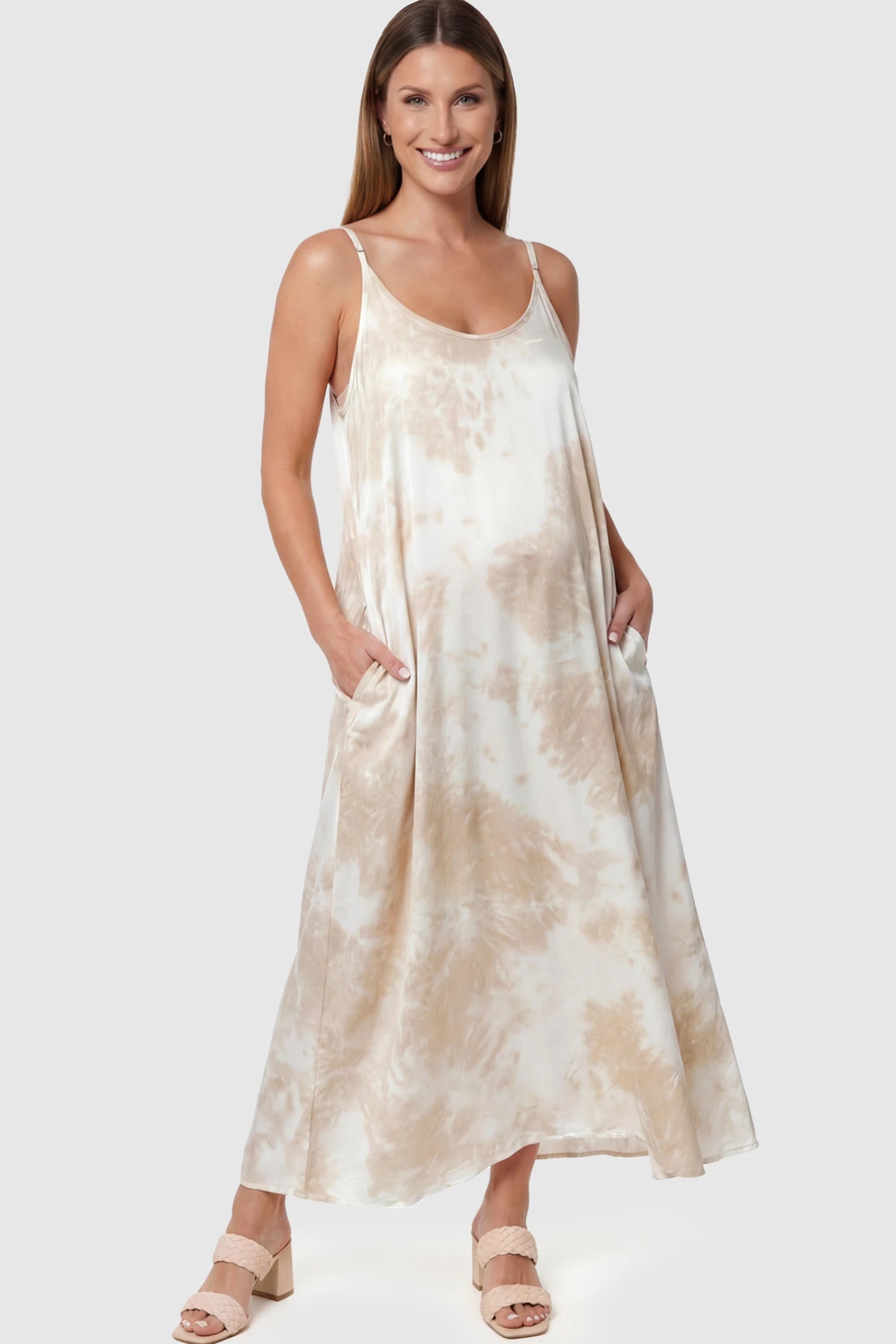 Tie-Dye Print Spaghetti Strap Maternity Maxi Dress Tie-Dye Print Spaghetti Strap Maternity Maxi Dress in Cream and White featuring side pockets on a pregnant model.