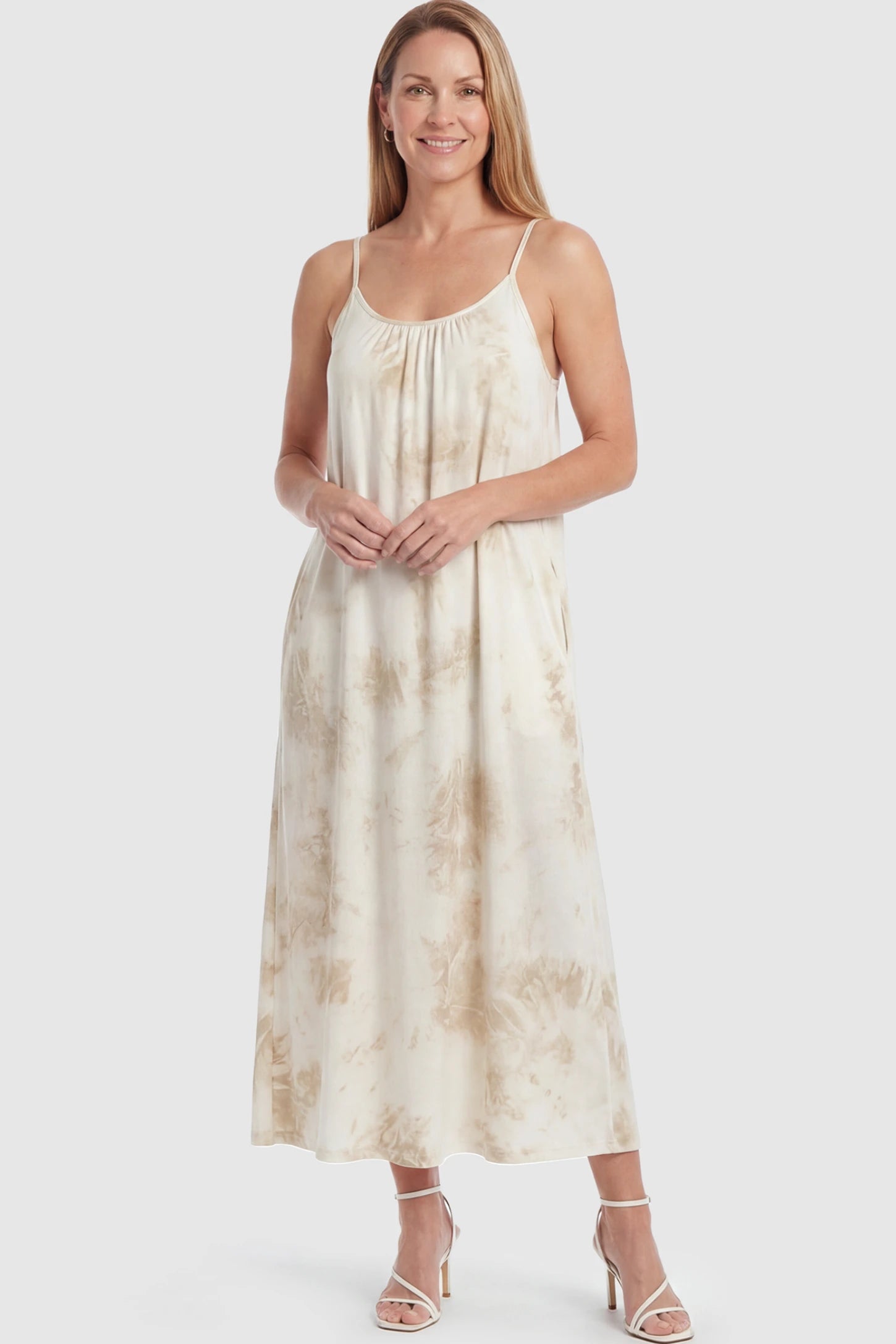 Tie-Dye Print Spaghetti Strap Maternity Maxi Dress Tie-Dye Print Spaghetti Strap Maternity Maxi Dress in Cream and White featuring side pockets on a postpartum model.