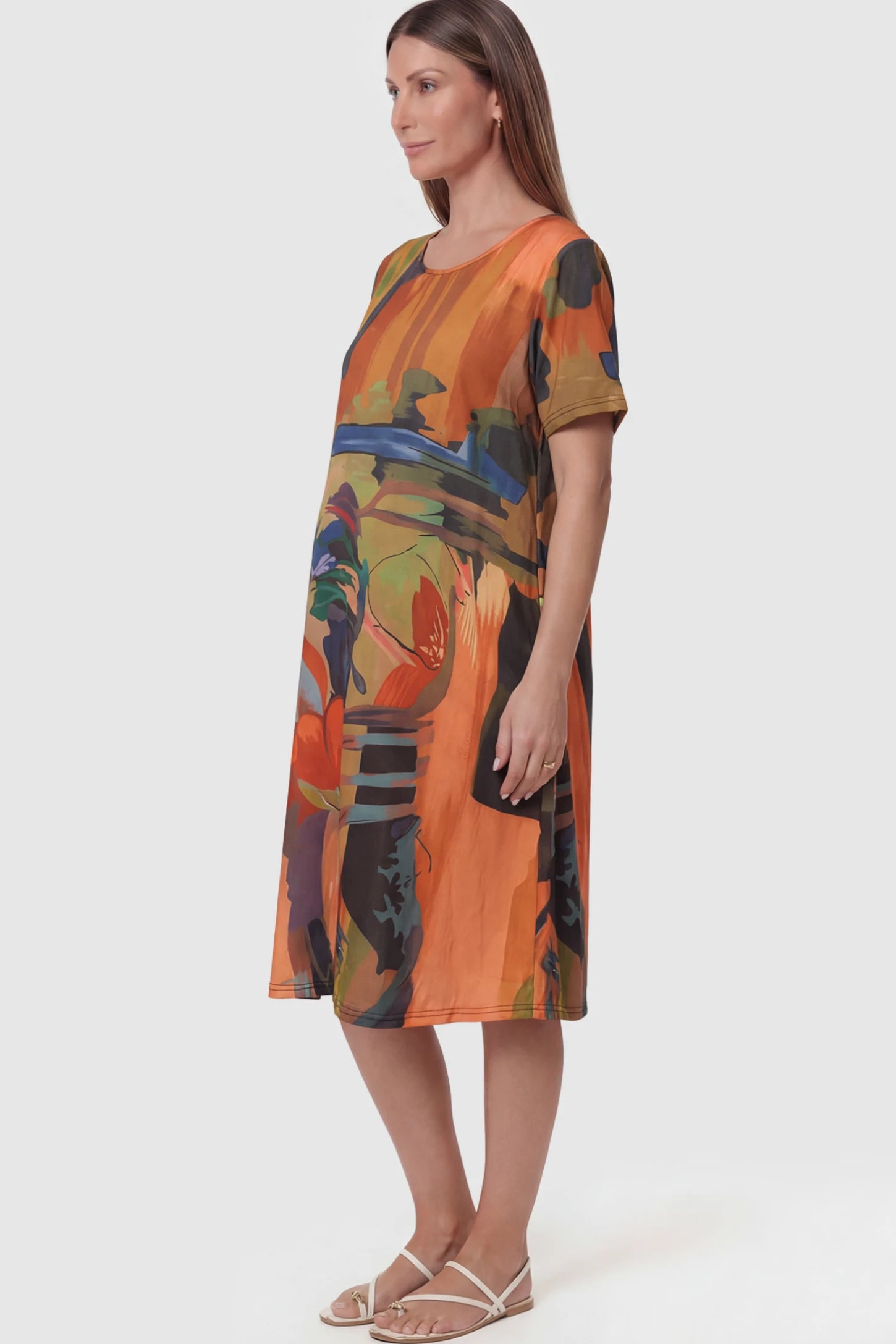 Abstract Print Scoop Neck Maternity Midi Dress in vibrant orange featuring a flowy A-line silhouette on a pregnant model.