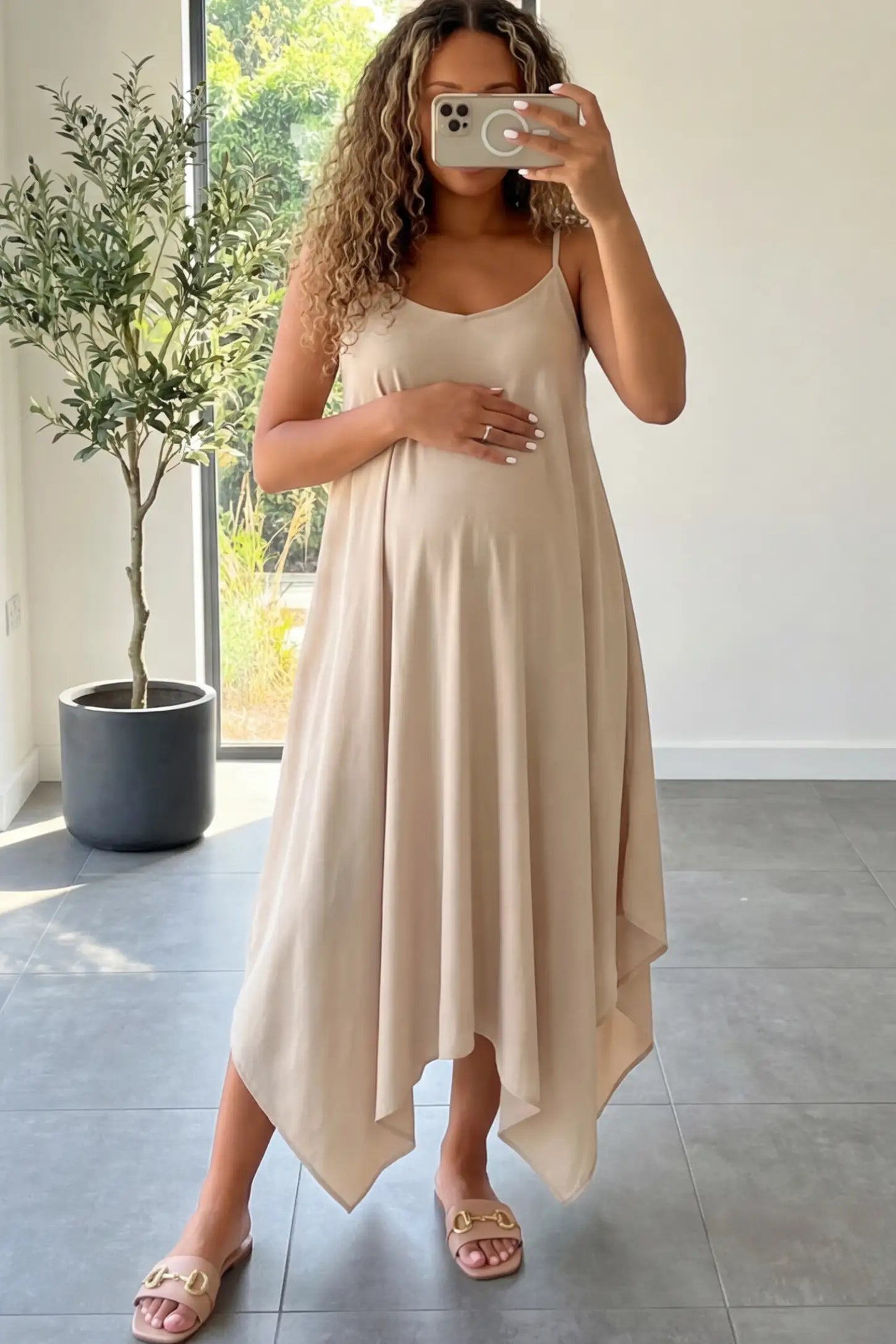 Spaghetti Strap Handkerchief Hem Maternity Midi Dress Spaghetti Strap Handkerchief Hem Maternity Midi Dress in Apricot featuring a scoop-neck on a pregnant model.